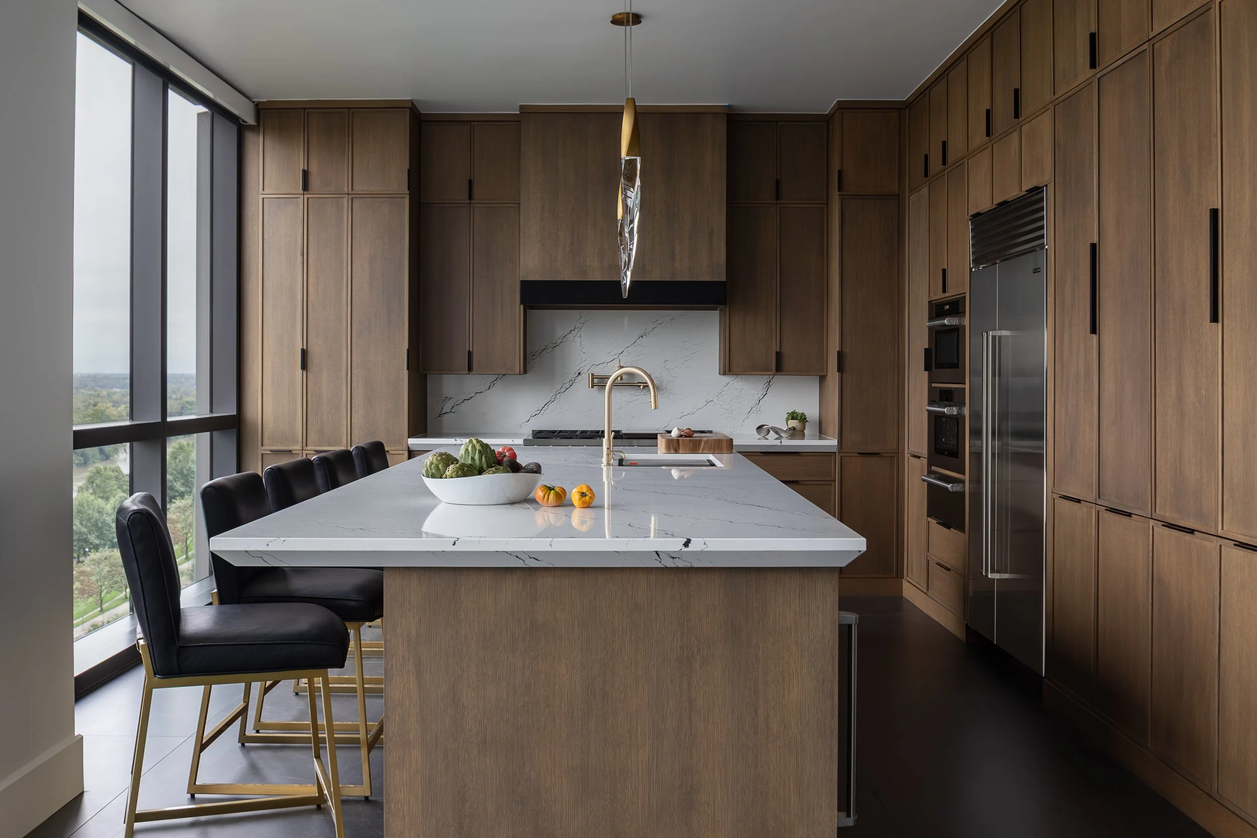 Kitchen of a modern condo in Downtown Columbus Ohio showcasing the luxury interior design of Benham + Co Interior Design.