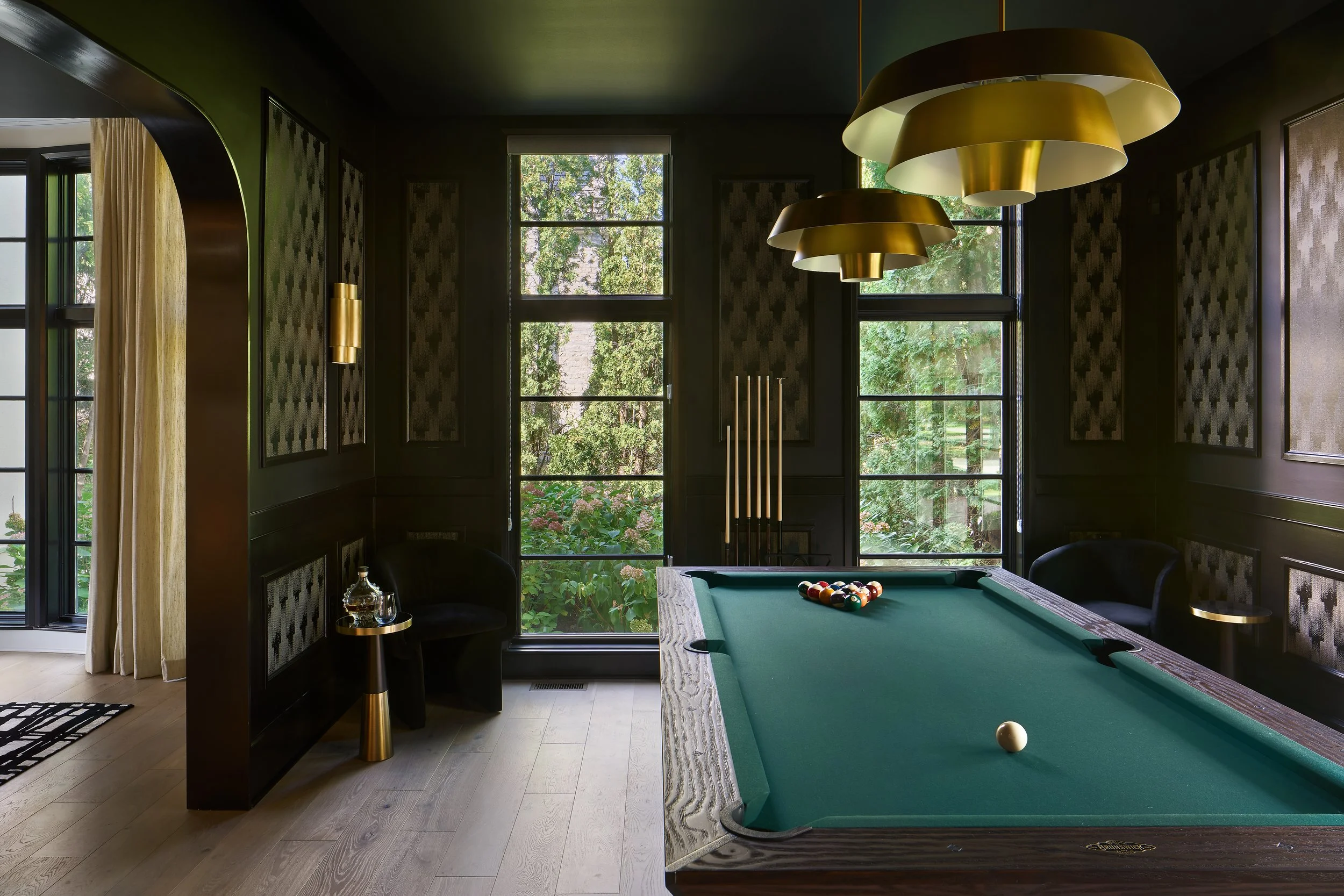 This dramatic game room in a luxury Bexley, Ohio home remodel was designed by Benham & Co Interior Design, a leading Columbus Ohio interior design firm specializing in full-service interior design and custom home renovations. Featuring rich, moody wa