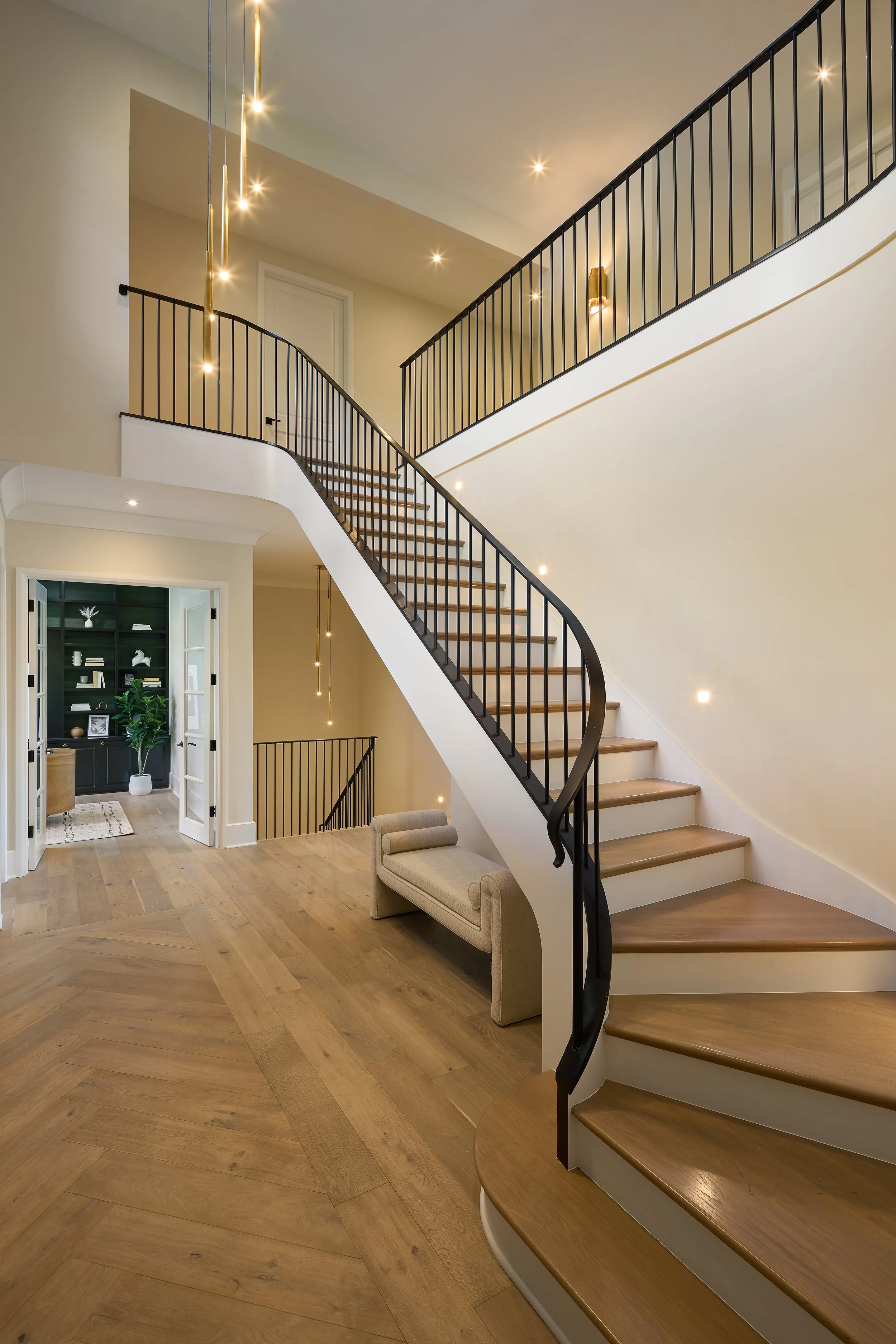 This stunning custom staircase design in a fully remodeled home in Bexley, Ohio highlights the refined craftsmanship of Benham & Co Interior Design, a premier Columbus Ohio interior designer offering full-service interior design and full home renovat