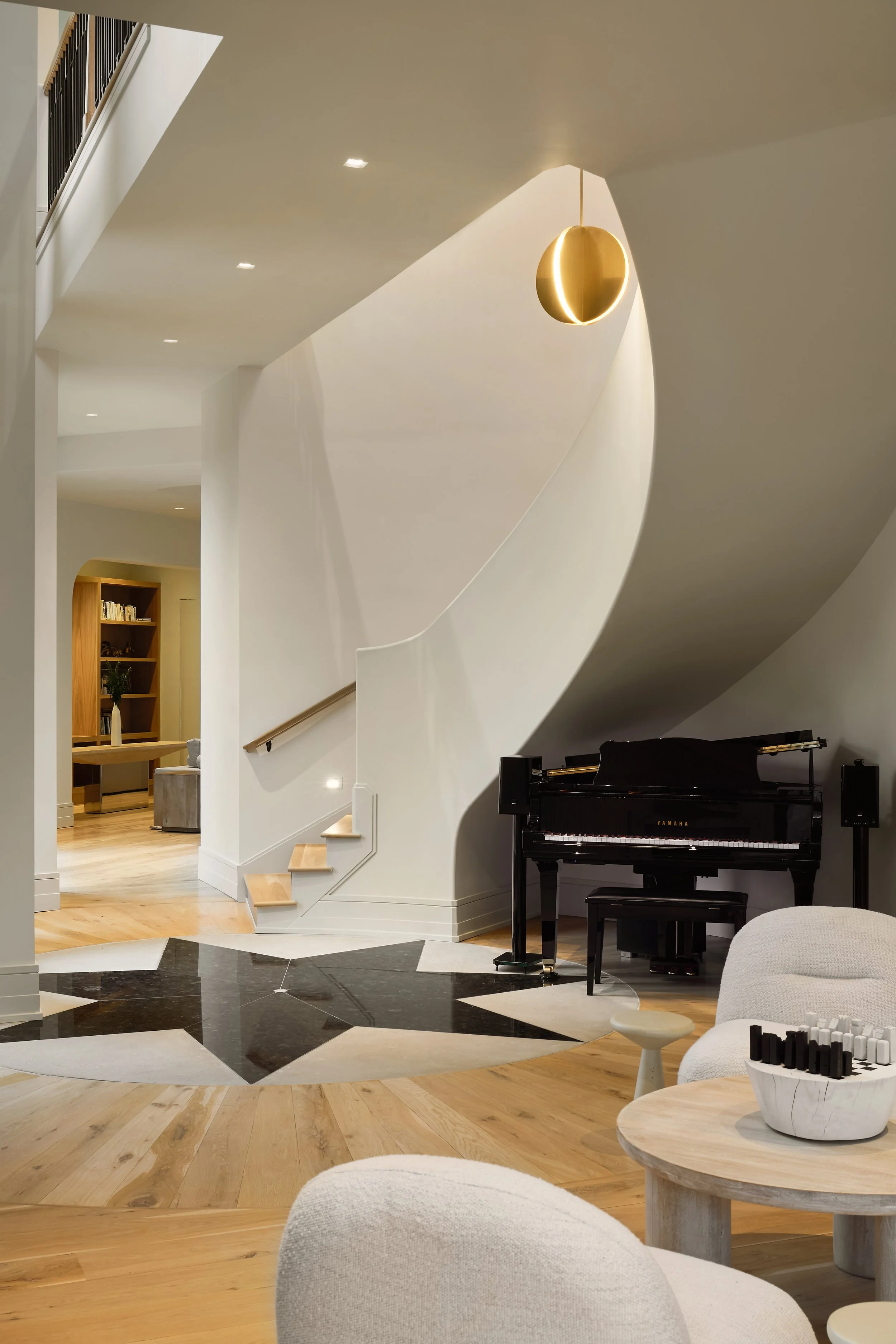 Modern Mediterranean spiral stair case with Bau Visual Comfort Lighting.   House located in Powell, Columbus, Ohio. Luxury Interior Design at it Best. 