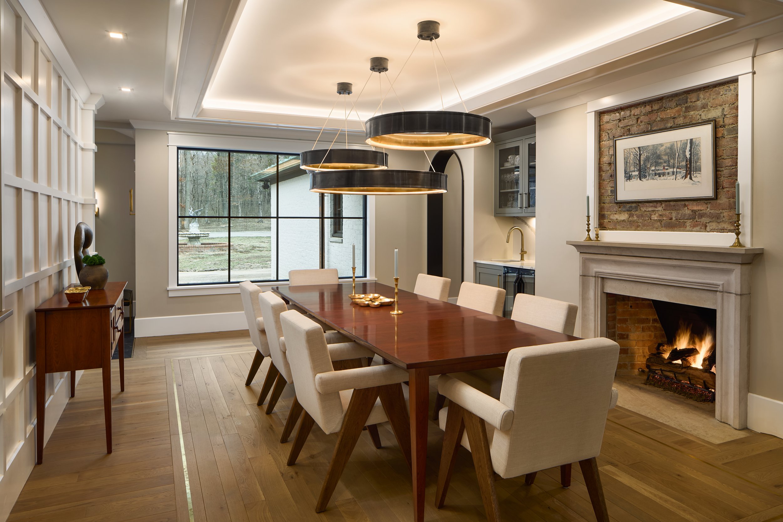 This custom dining room by Benham & Co Interior Design, a leading Columbus Ohio interior designer, reflects a refined approach to luxury dining room design in Westerville, Ohio. The space features a warm wood dining table paired with tailored upholst