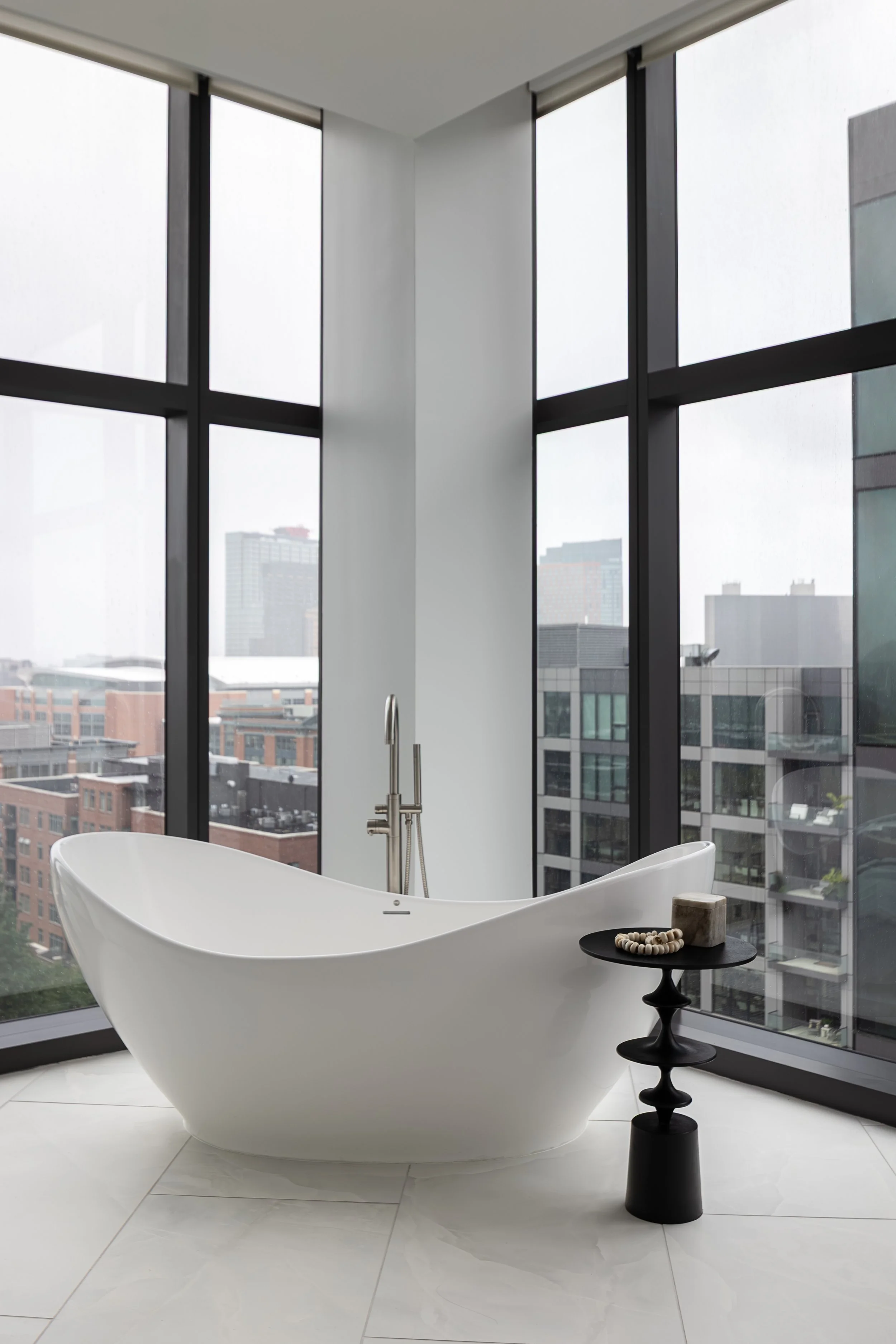 Freestanding bath tub in a modern condo in Downtown Columbus Ohio showcasing the luxury interior design of Benham + Co Interior Design.
