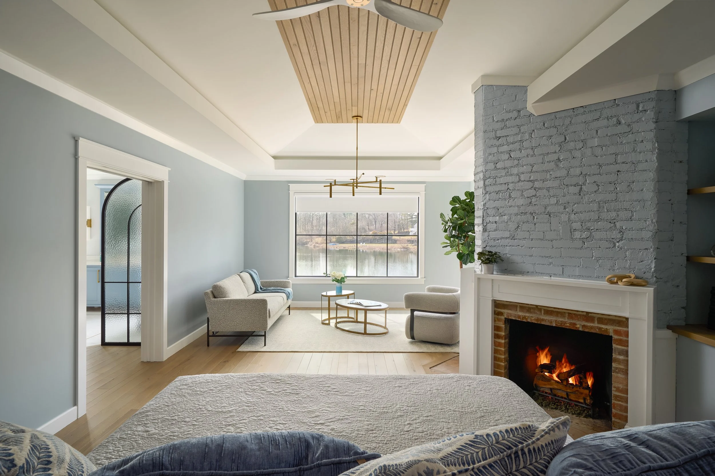 This custom bedroom and sitting area by Benham & Co Interior Design, a leading Columbus Ohio interior designer, reflects a refined approach to luxury residential interior design in Westerville, Ohio. The space features a calming palette of soft blues