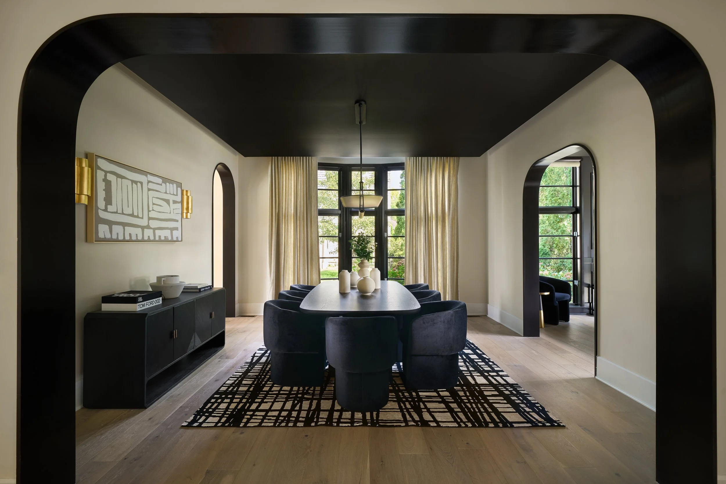 This sophisticated dining room in a fully remodeled home in Bexley, Ohio was designed by Benham & Co Interior Design, a premier Columbus Ohio interior designer specializing in full-service interior design and luxury home renovations. Framed by dramat