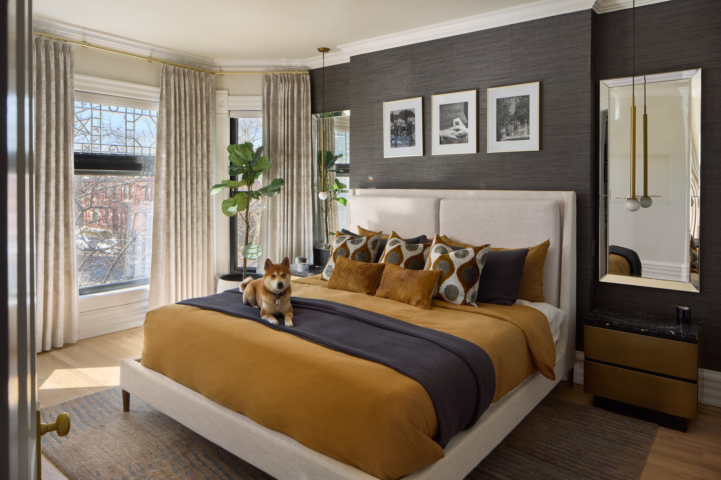 This refined primary bedroom in a beautifully renovated Victorian home in Columbus, Ohio was designed by Benham & Co Interior Design, a leading Columbus Ohio interior designer specializing in luxury residential interiors and full-home renovations. Fe