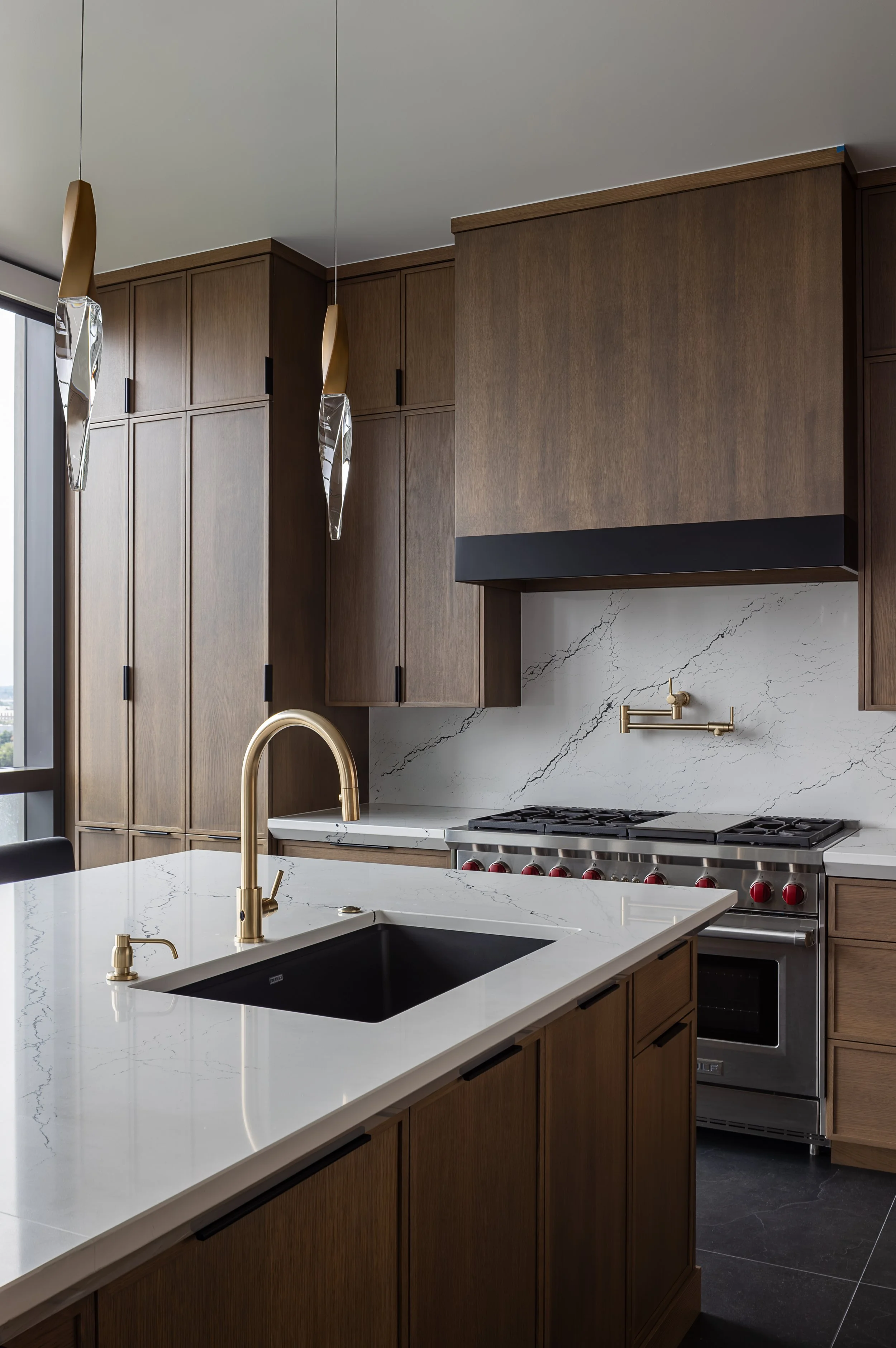 Kitchen of a modern condo in Downtown Columbus Ohio showcasing the luxury interior design of Benham + Co Interior Design.
