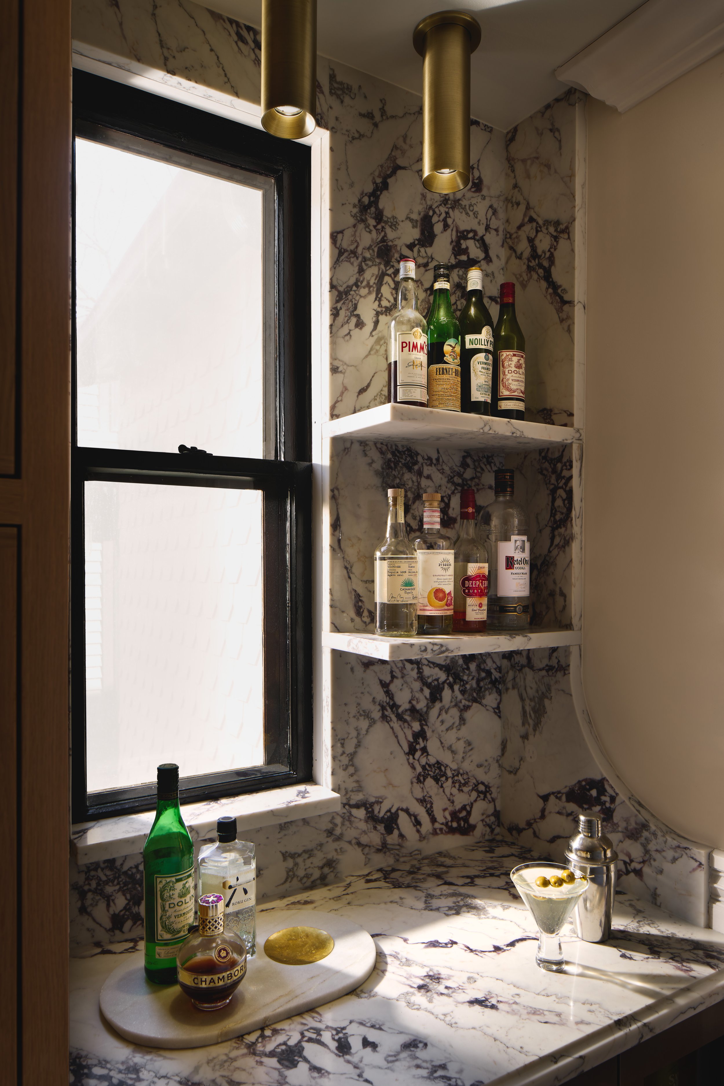 This custom bar detail in a historic Victorian home in Columbus, Ohio was designed by Benham & Co Interior Design, a premier Columbus Ohio interior designer specializing in luxury residential interiors and full-service renovations. Featuring dramatic