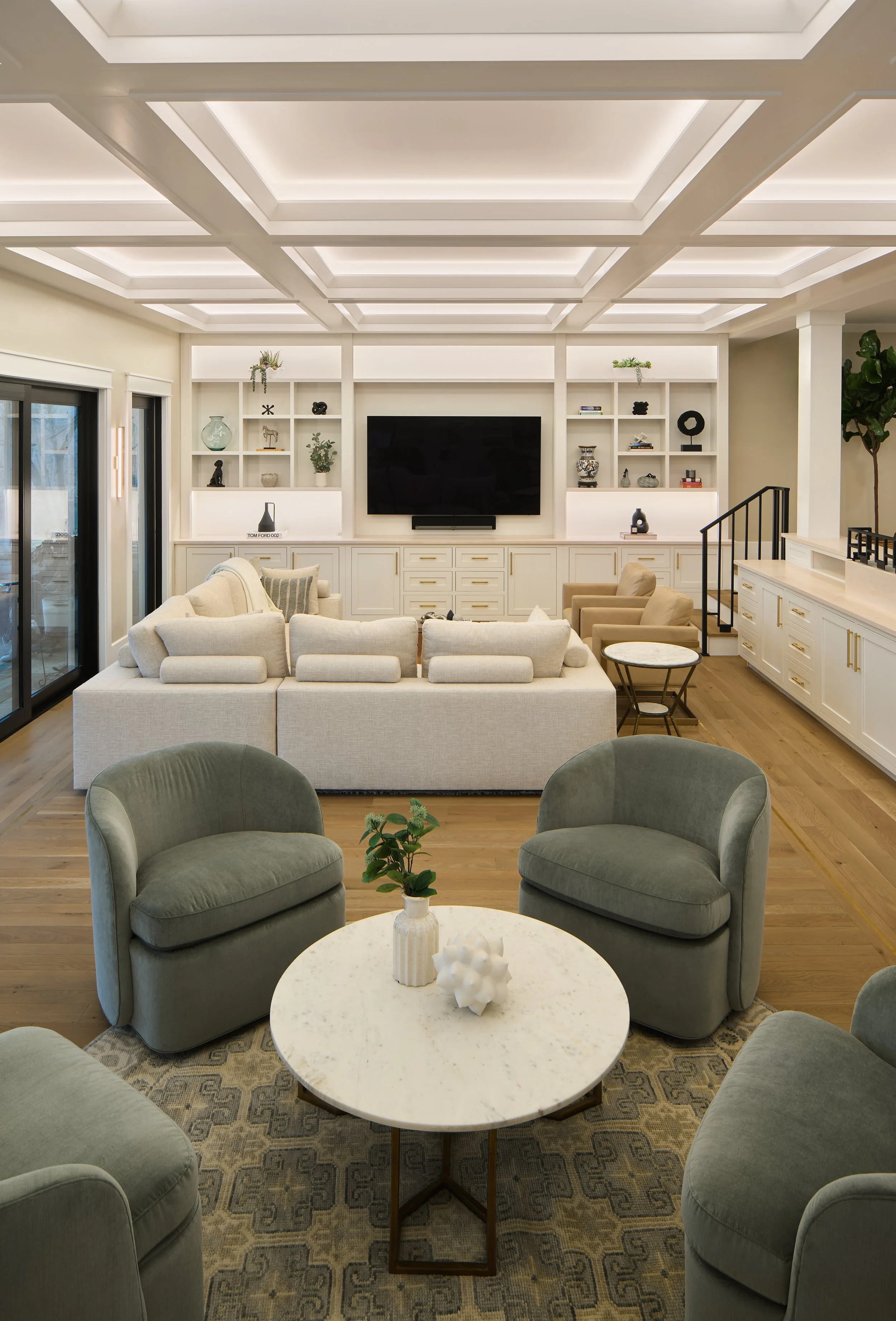 This custom living room by Benham & Co Interior Design, a premier Columbus Ohio interior designer, showcases a refined approach to luxury residential interior design in Westerville, Ohio. The space features a custom coffered ceiling with integrated l