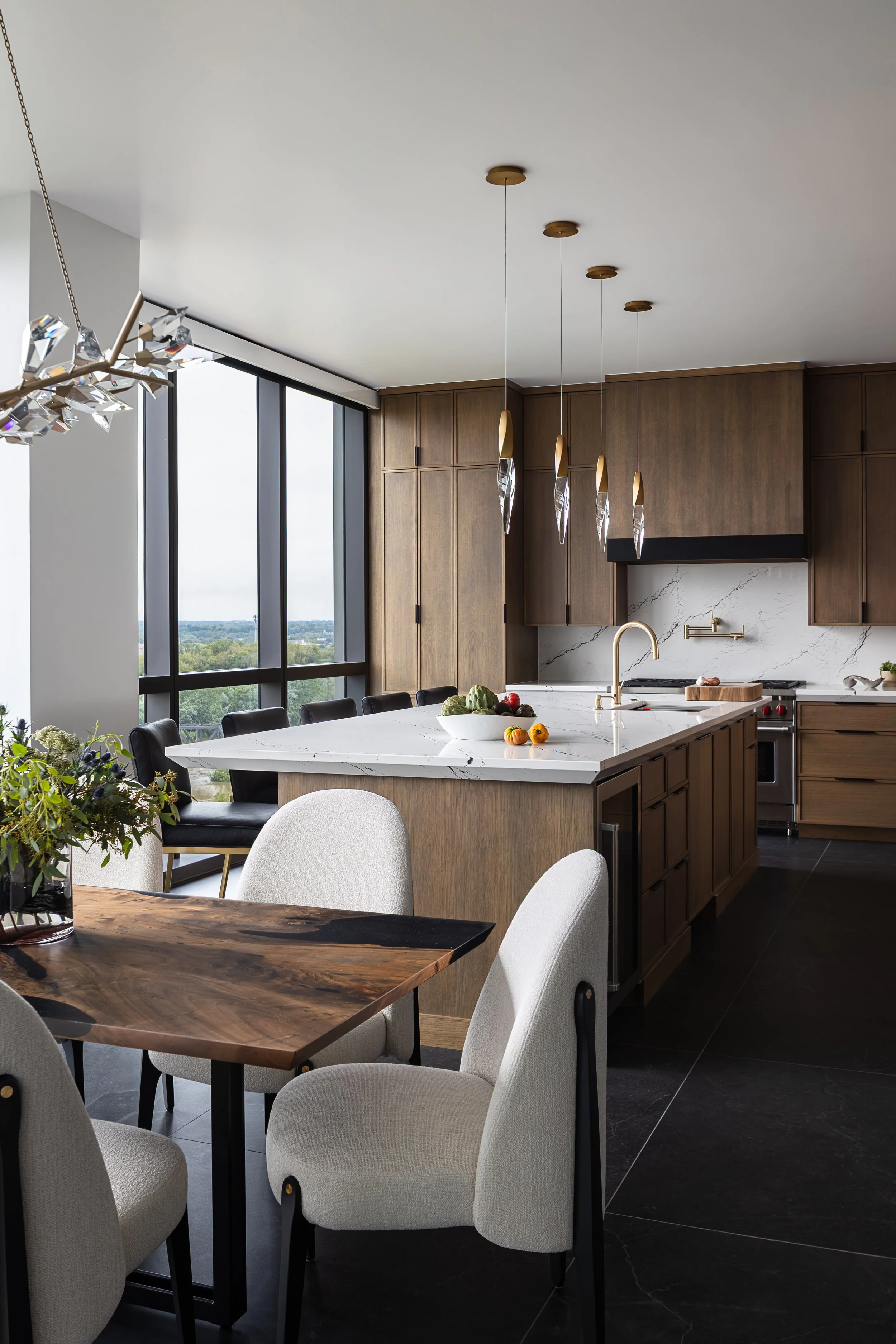 Kitchen and Dining room of a modern condo in Downtown Columbus Ohio showcasing the luxury interior design of Benham + Co Interior Design.