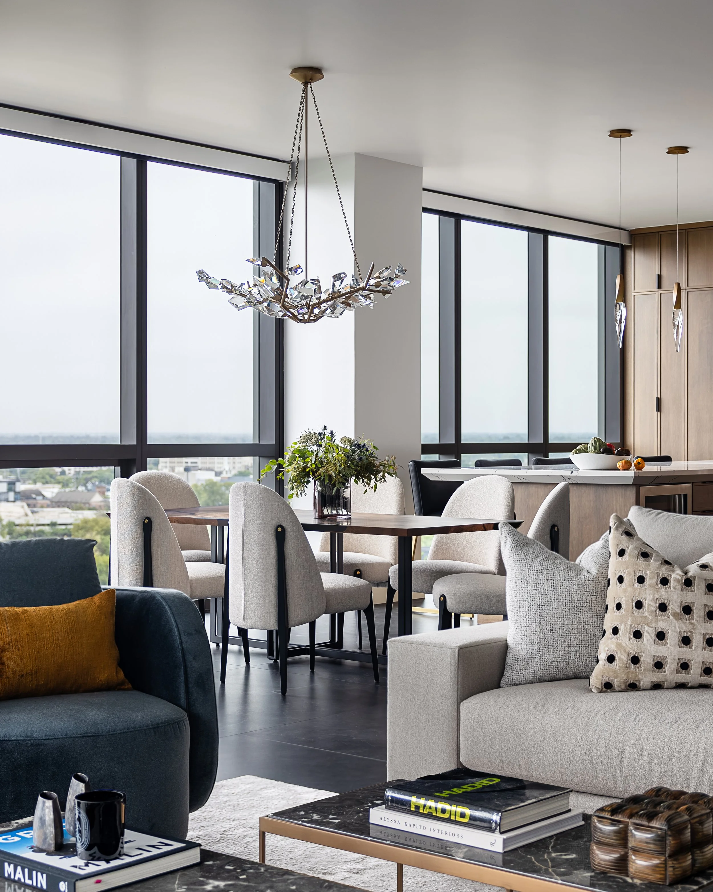 Living Room and Dining room of a modern condo in Downtown Columbus Ohio showcasing the luxury interior design of Benham + Co Interior Design.