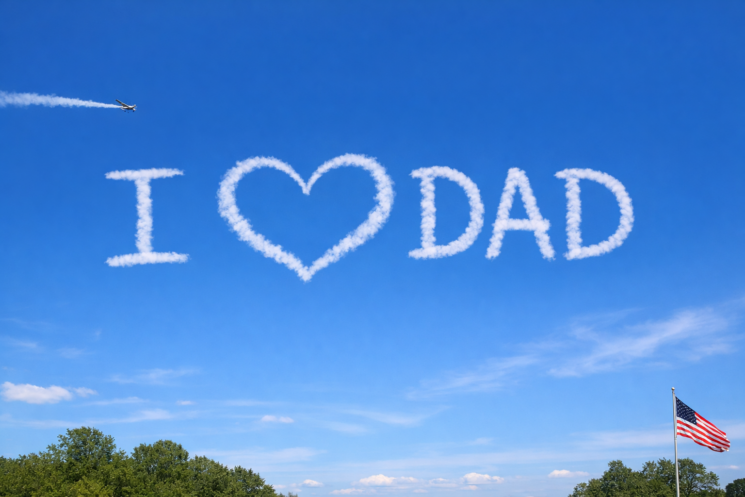 Skywriting in the shape of a message that says 'I ♥ DAD' with a plane trailing white smoke, American flag on a pole, and green trees below on a partly cloudy day.