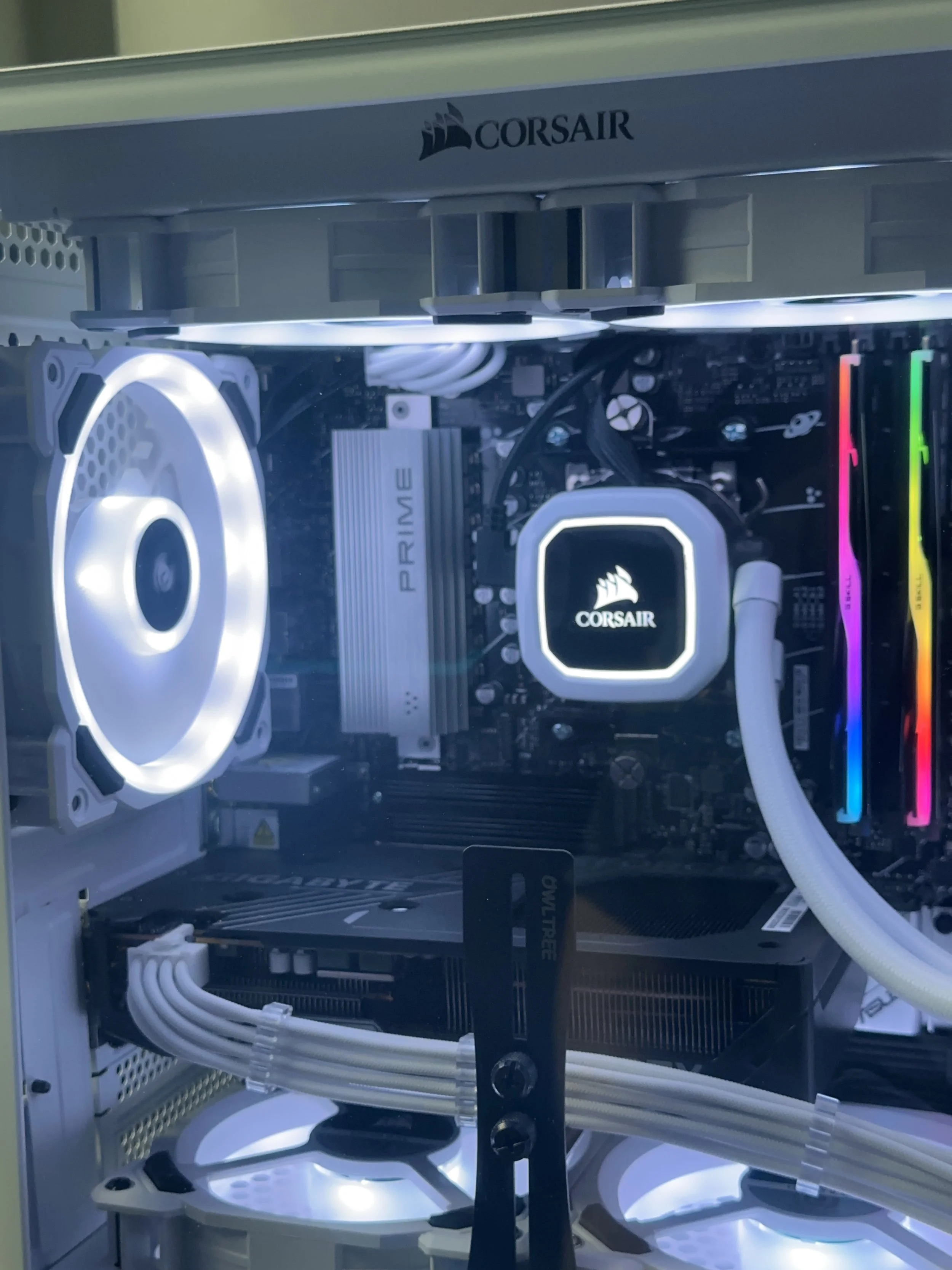 White custom gaming PC interior with Corsair cooling, RGB memory, and clean cable management