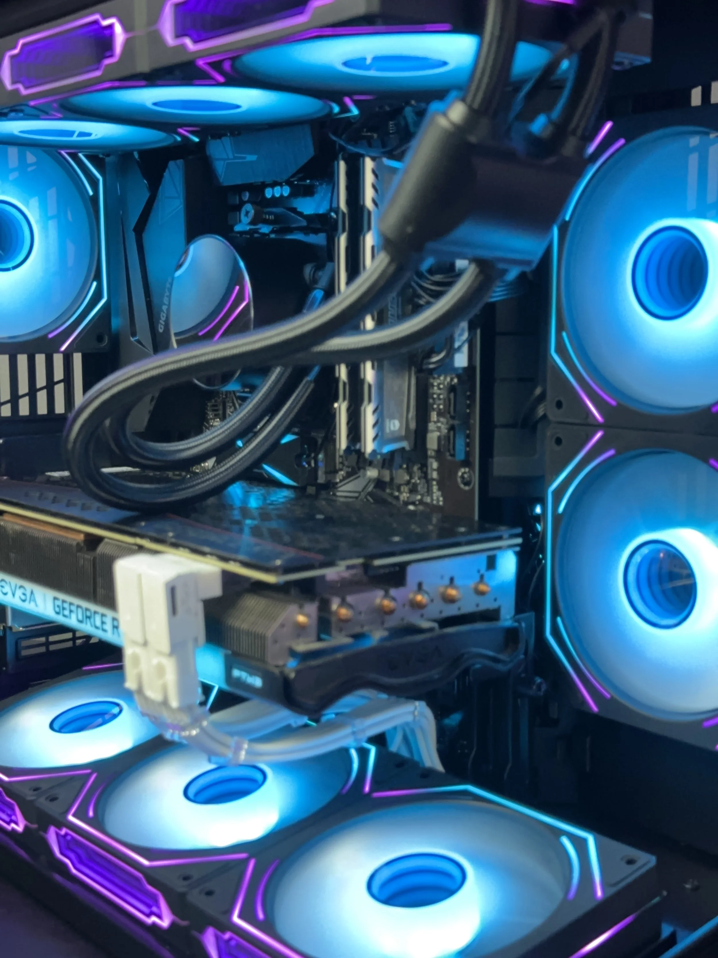 Cyan and purple RGB custom gaming PC with liquid cooling and multiple case fans