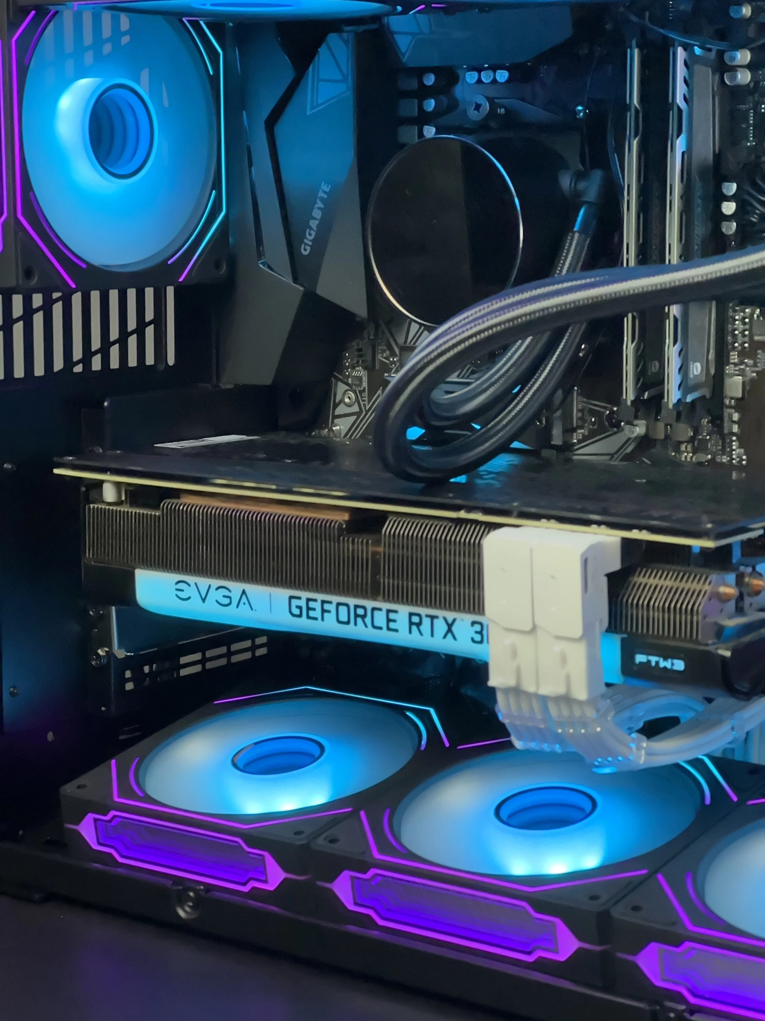 Cyan and purple custom gaming PC interior with RTX graphics card and RGB cooling