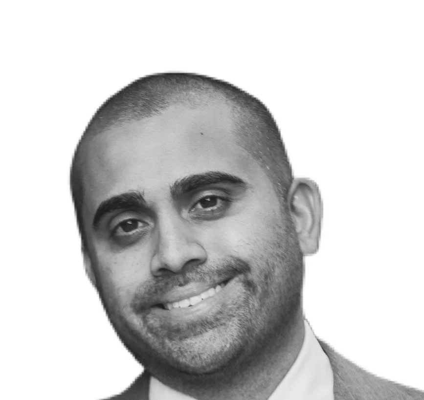 Black and white portrait of a man with short haircut, smiling slightly