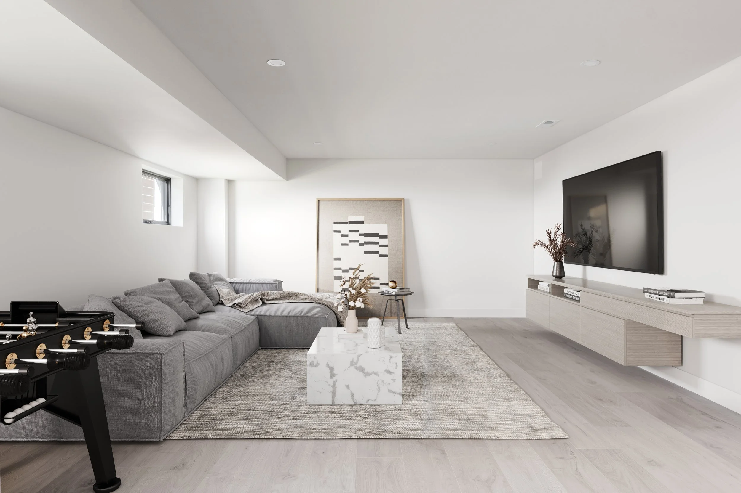 Minimalist living room with gray sectional sofa, white marble coffee table, wall-mounted TV, light wood flooring, and modern artwork.