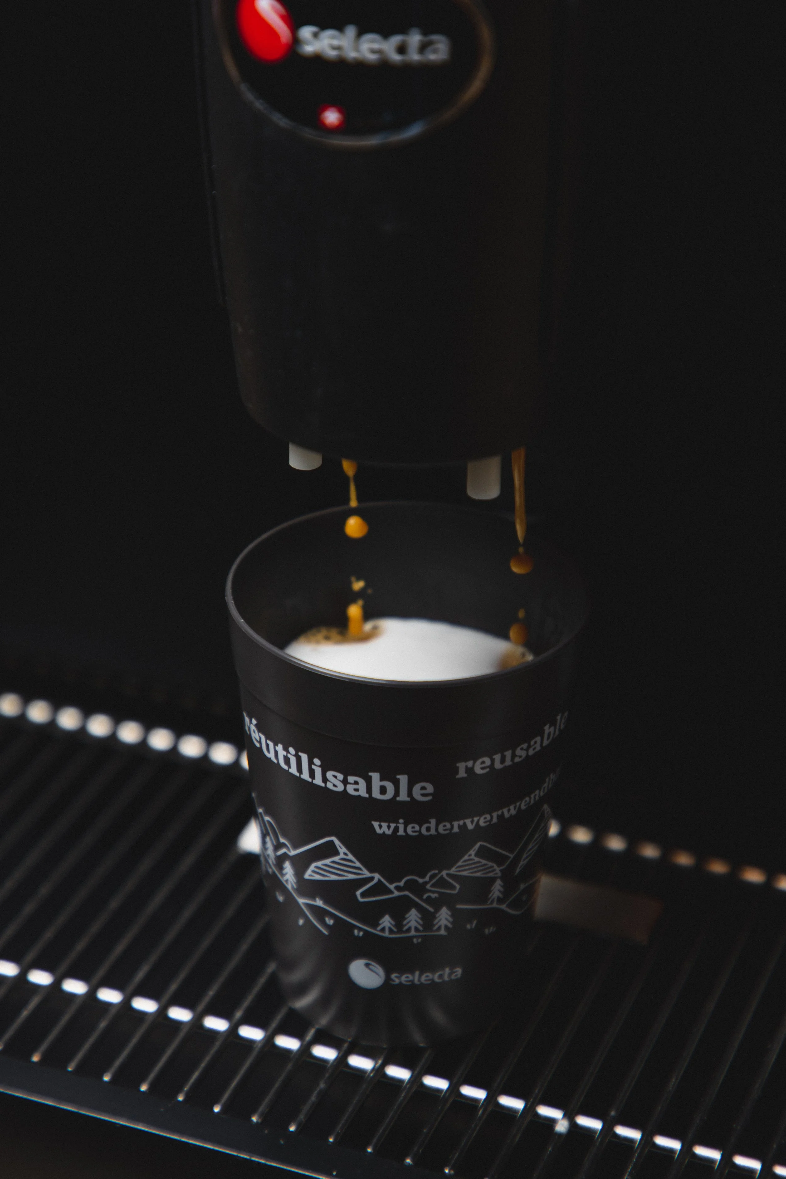 Fresh coffee pouring into a reusable Selecta cup from a self-serve machine, highlighting sustainable, fully managed coffee solutions and eco-friendly on-the-go convenience..jpg