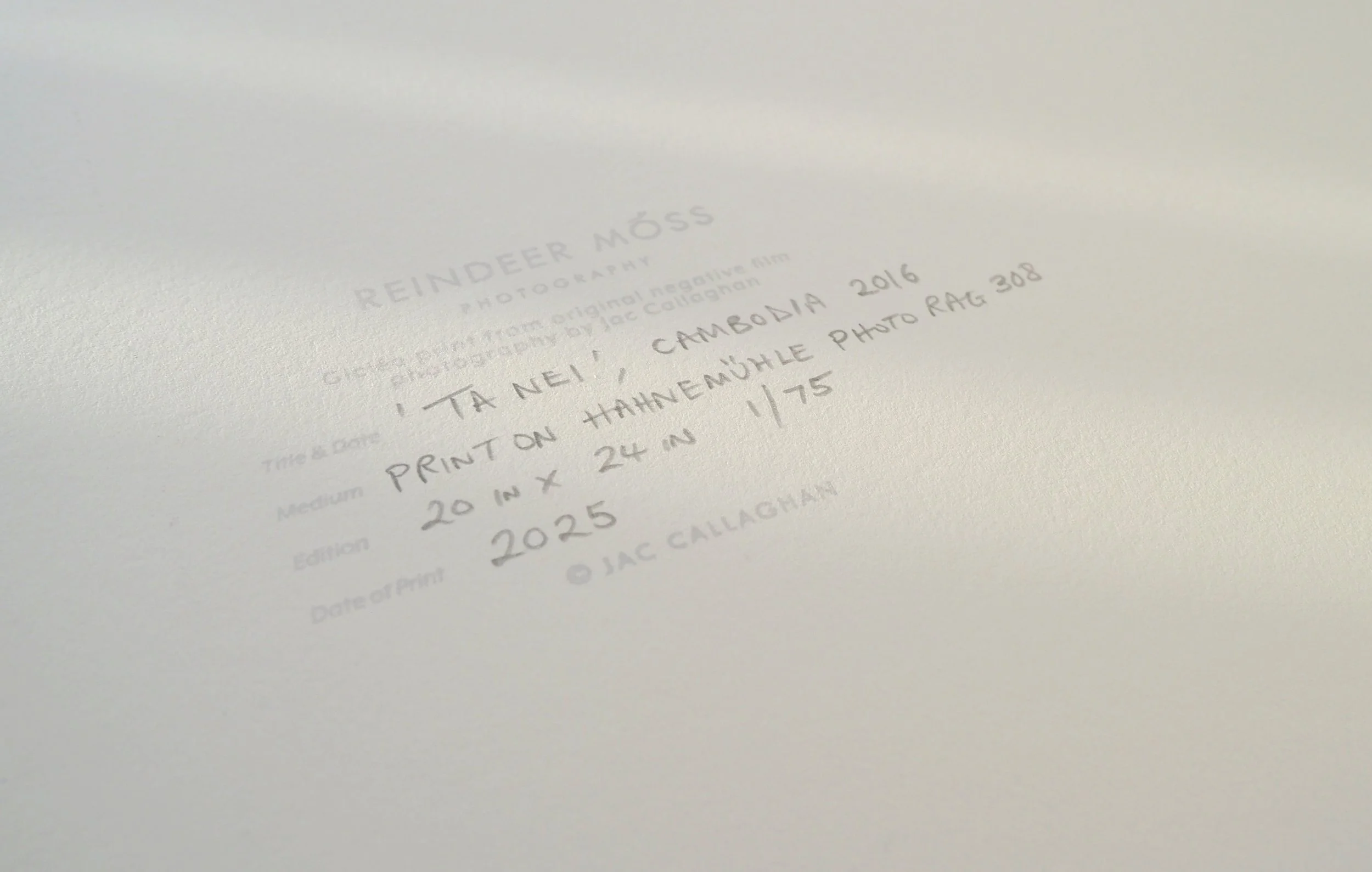 Close up photograph showing a stamp with details of print written in pencil