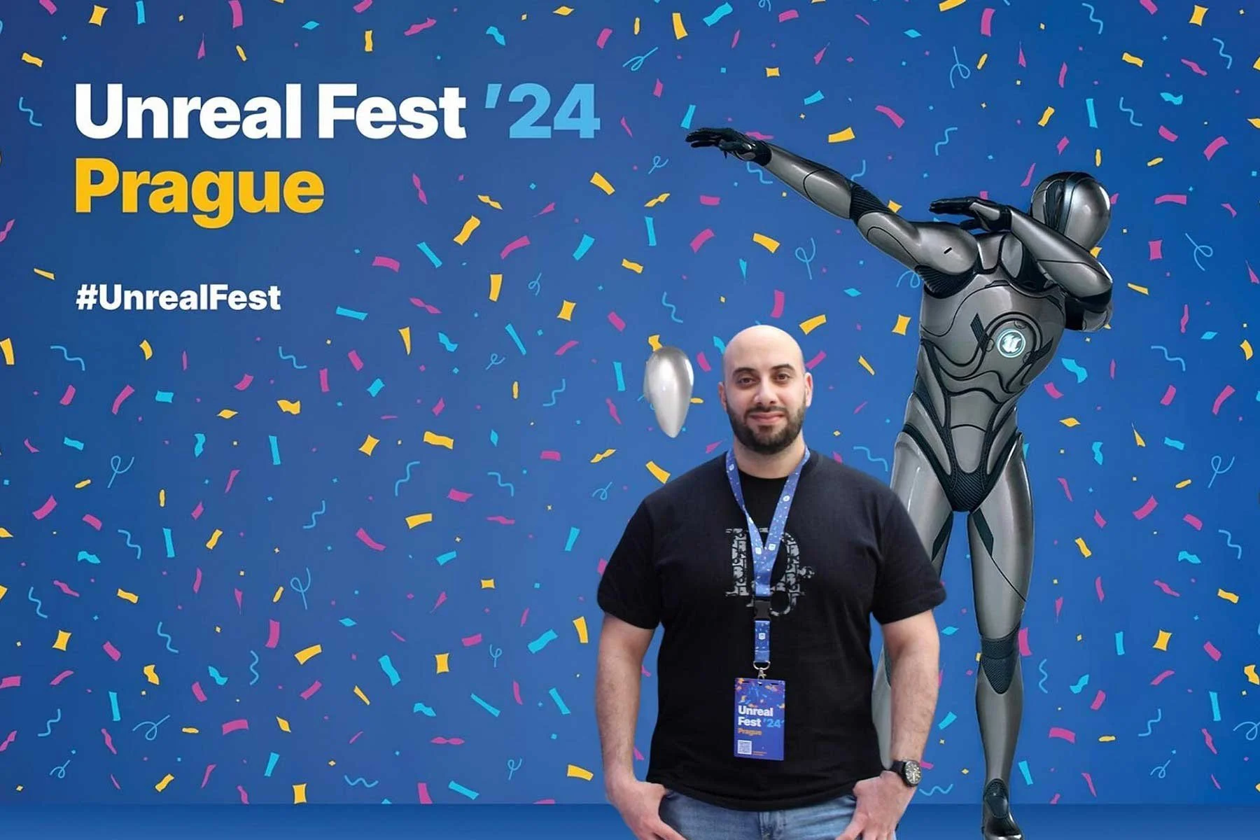 A man standing in front of a vibrant backdrop at Unreal Fest 2024 in Prague, with a futuristic robotic figure and confetti designs.