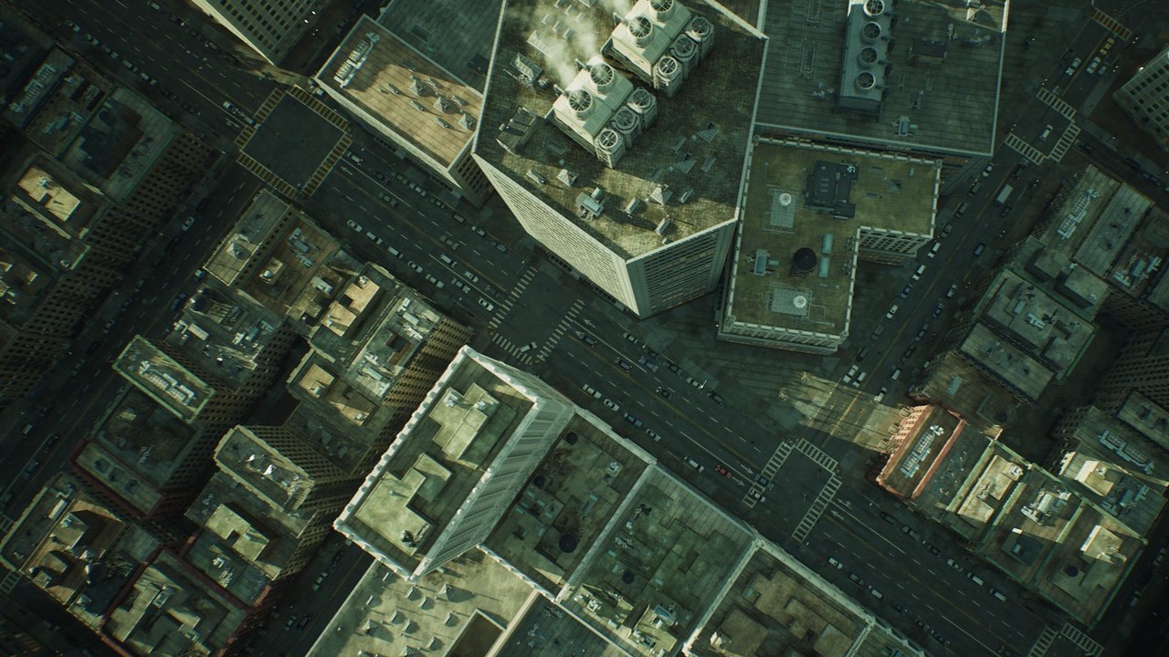 Aerial view of a cityscape showing tall buildings, streets, and rooftops