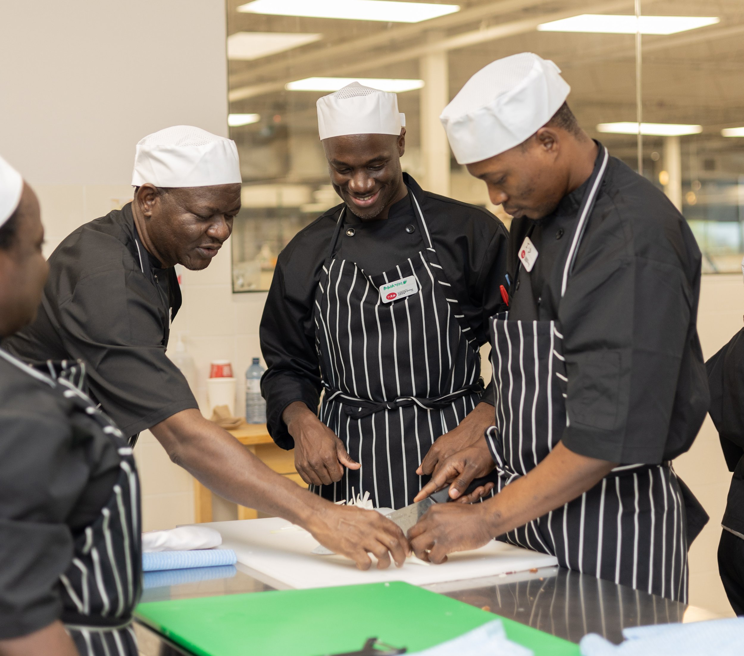 Group of culinary trainees in kitchen