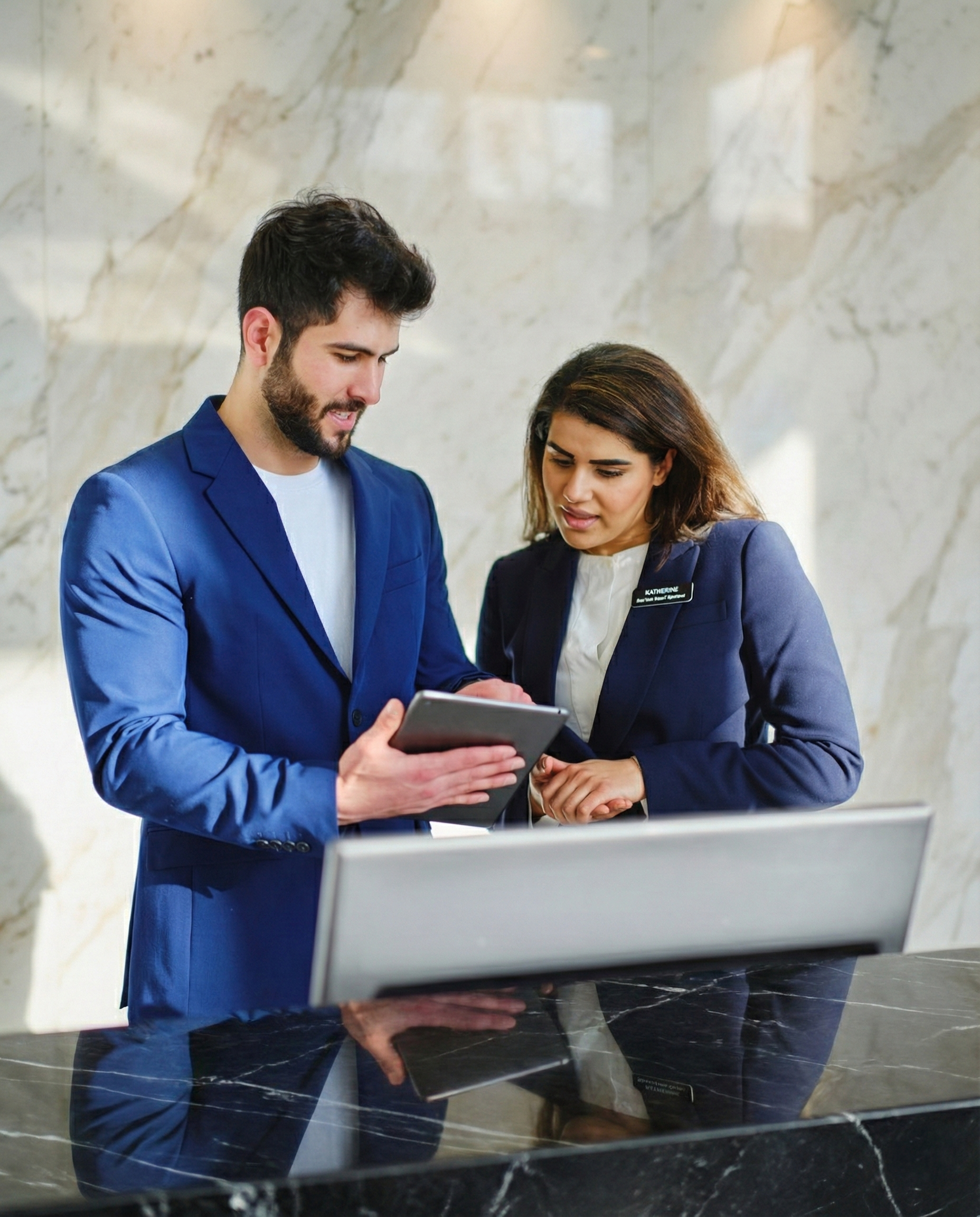 Man and women at hotel front desk