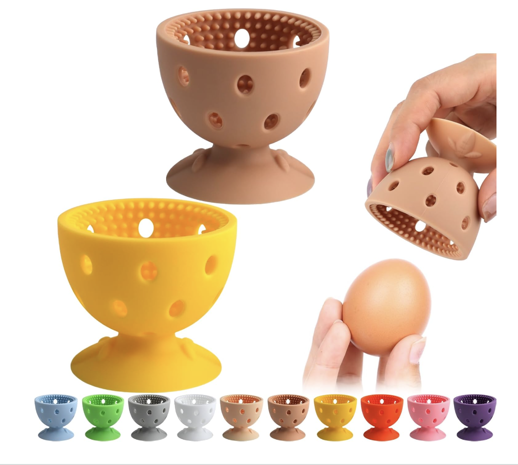 Two silicone egg washing brushes in yellow and brown, designed to gently scrub dirt from fresh heritage duck eggs without breaking the shells.