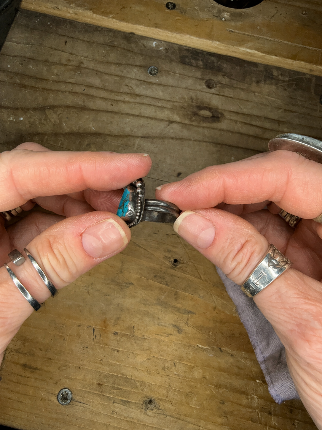 A handmade M7 Trading Post sterling silver and turquoise ring showing natural tarnish.