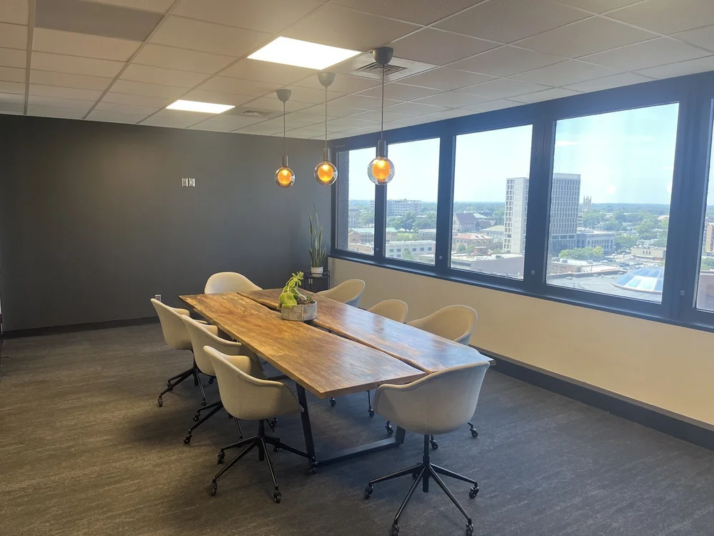 Modern conference room with large windows and a city view