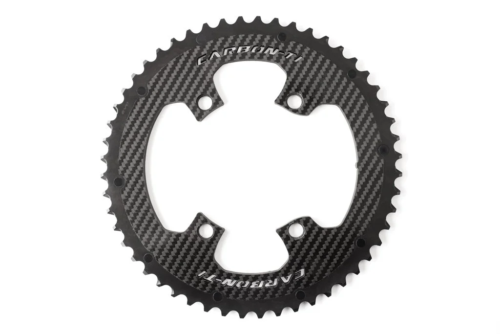 Carbon fiber bicycle chainring with the brand name 'Carbon T' engraved on it.