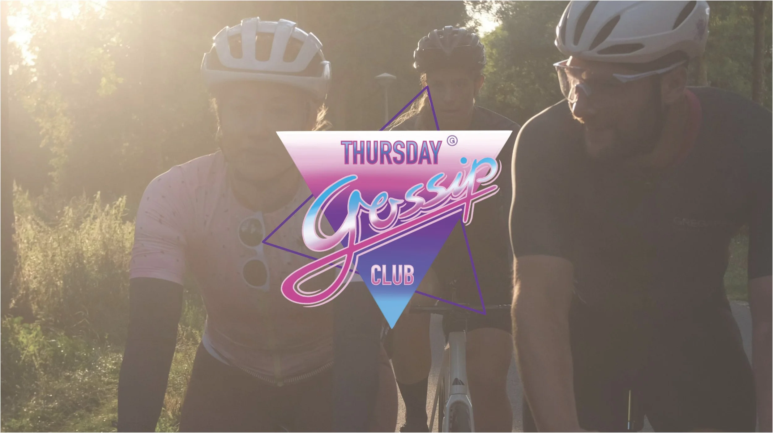Man balancing on a bike while doing a horizontal plank on a bridge.