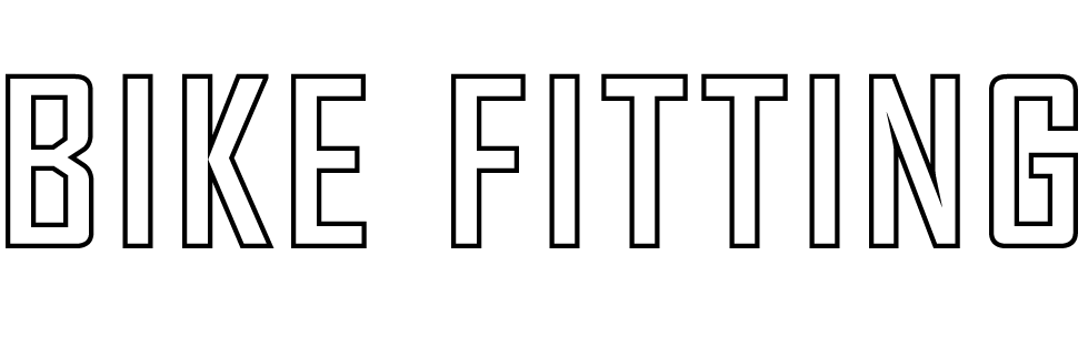 A person3307-) with a black shirt, black pants and glasses, baking bread in a modern kitchen with stainless steel appliances and a wood countertop.