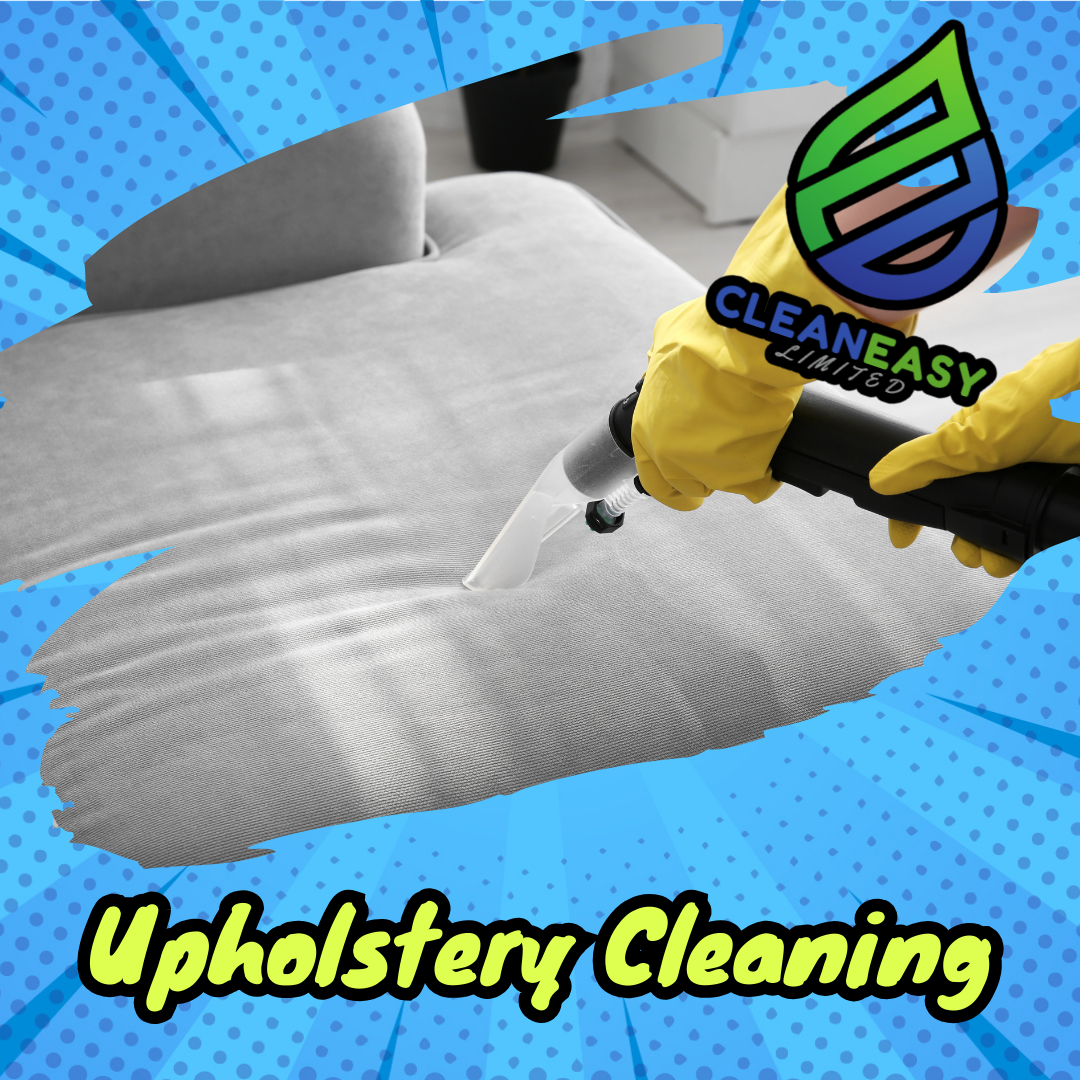 A person wearing yellow gloves using a steam cleaner on a gray upholstered couch.