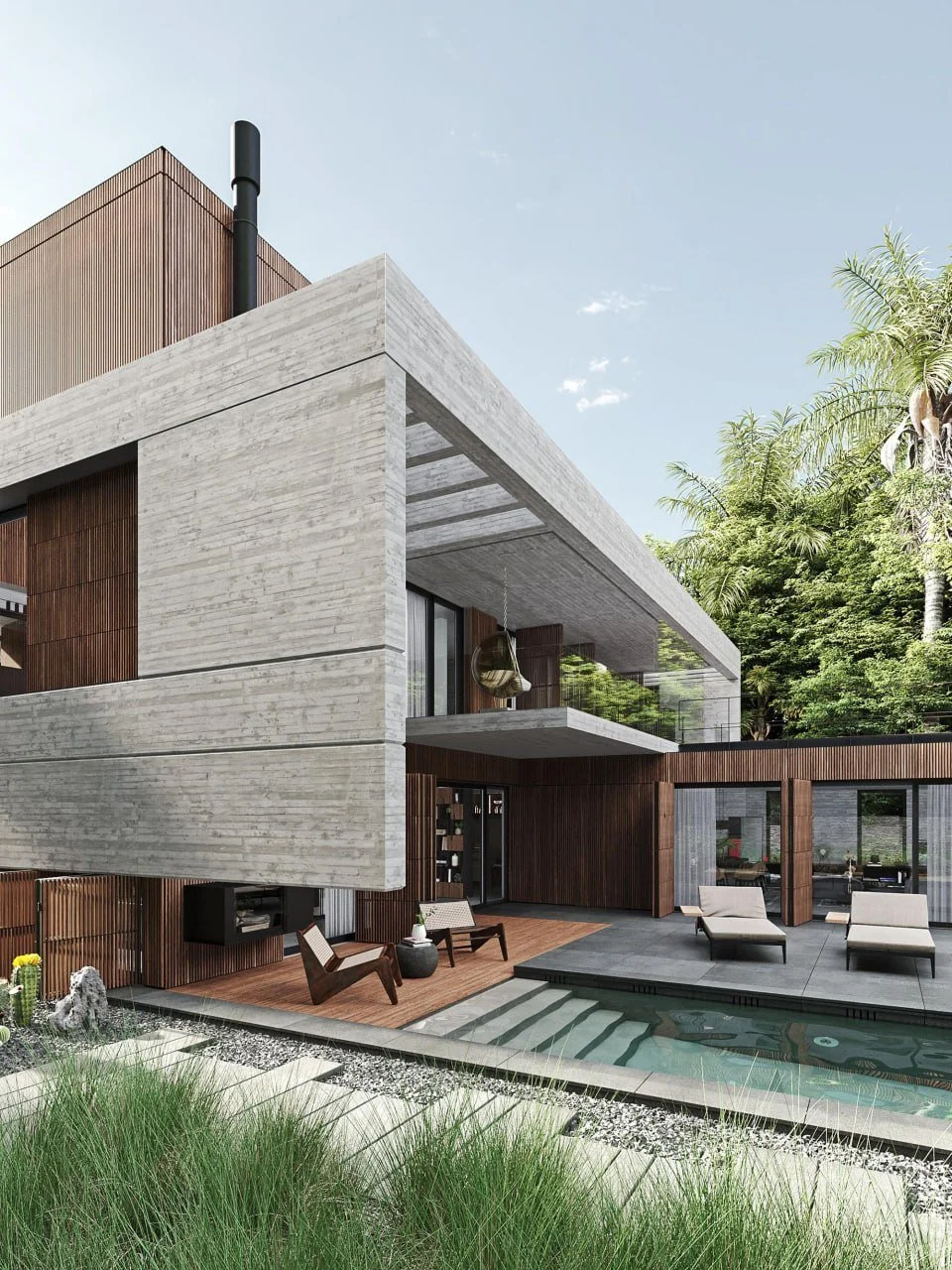 Modern two-story house with concrete and wooden exterior, large balcony, adjacent swimming pool, outdoor lounge chairs, and lush green trees in the background