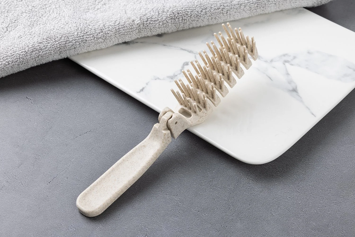 環境配慮素材 折りたたみコーム（アイボリー系／粒入り）
折りたたみ時 約9.5cm、展開時 約18cm。携帯しやすい折りたたみ仕様で、ホテルアメニティに適しています。お客様のご要望に合わせて印刷（名入れ・ロゴ）対応可能です