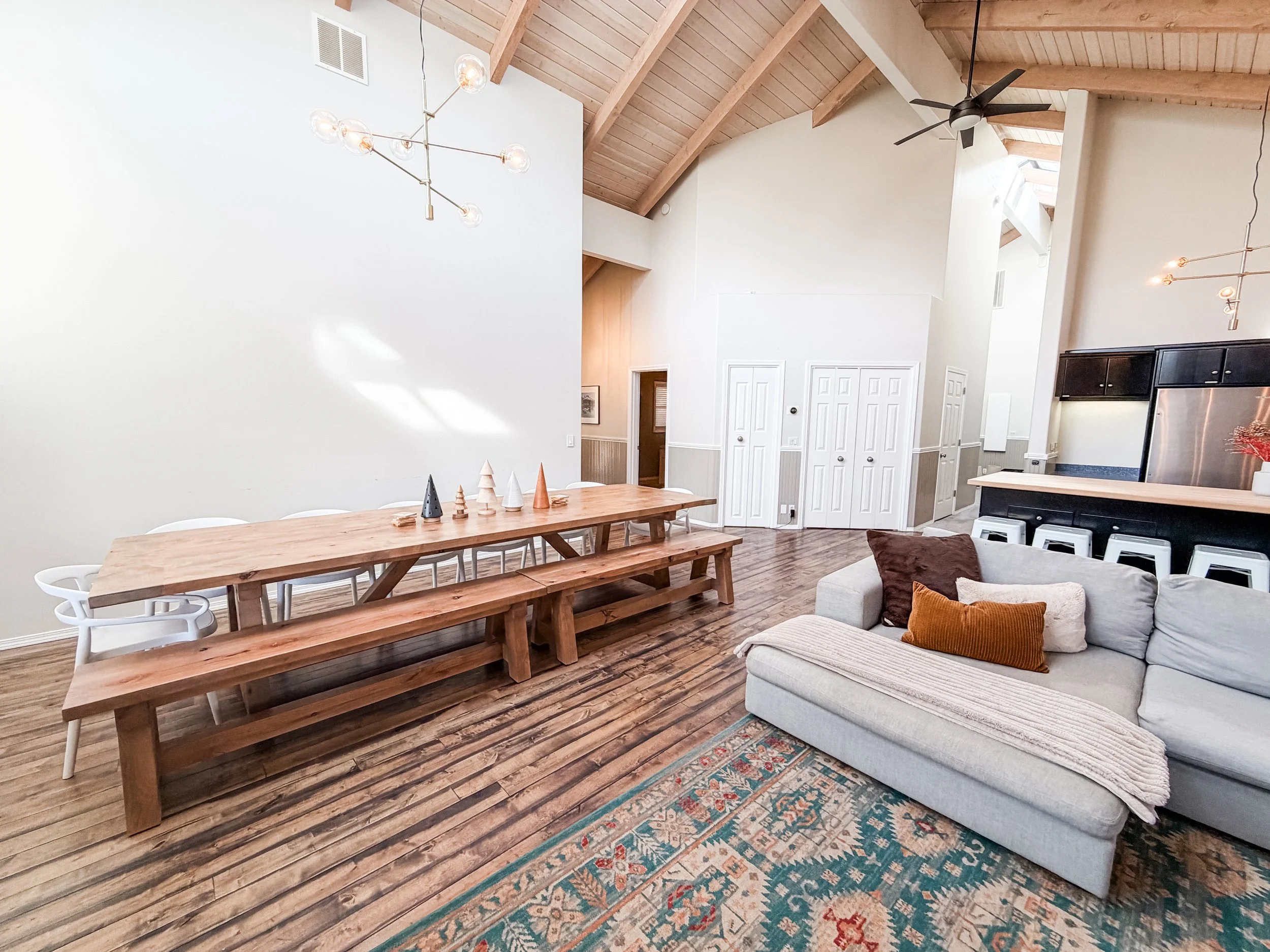 Dining area with 12 foot long dining table, benches and chairs. Additional chairs and a folding tables available.