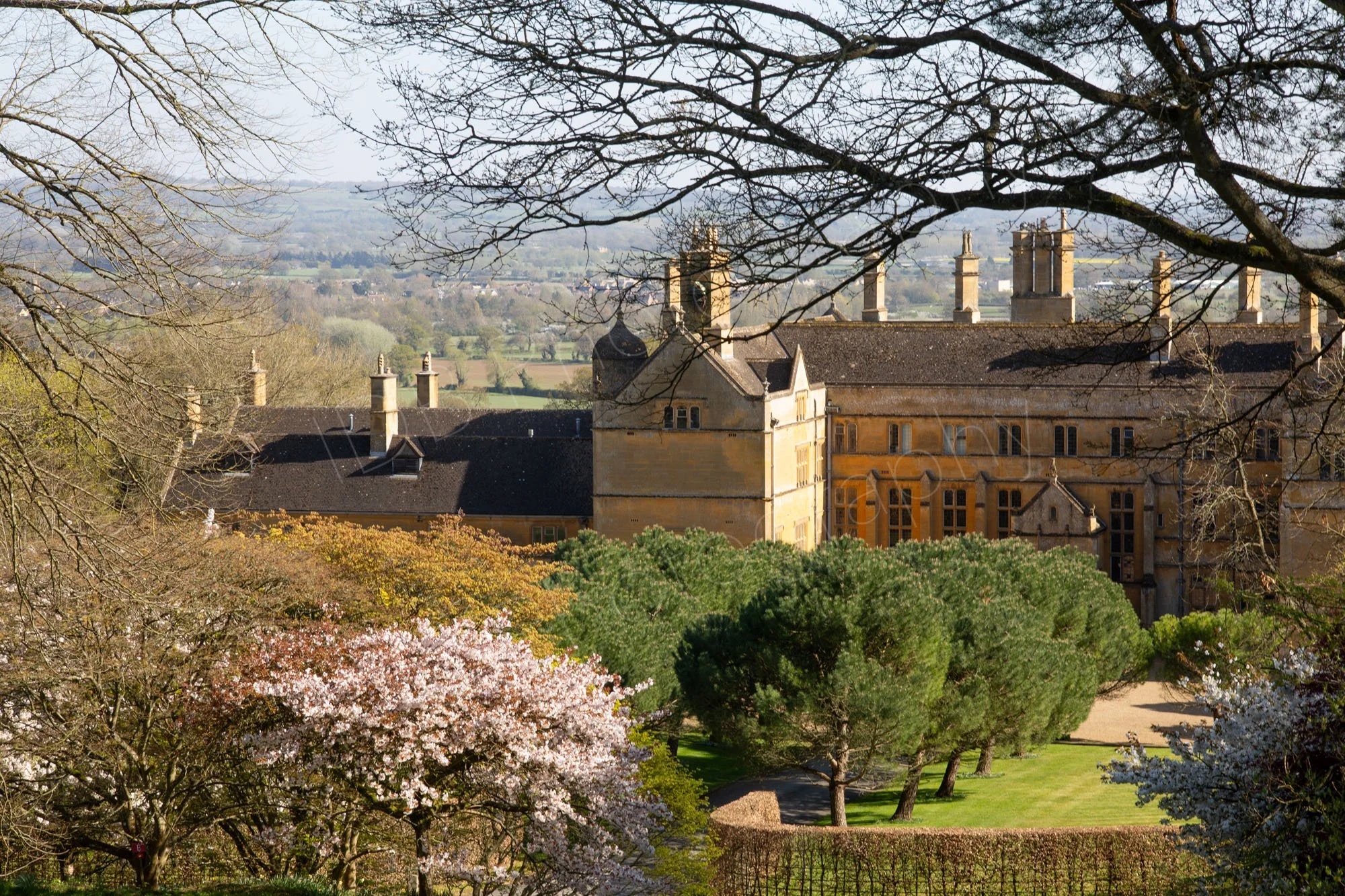 Batsford House near Moreton, Gloucestershire with it's rich honey stonework and beautiful surrounding trees and shrubs at Batsford Arboretum.