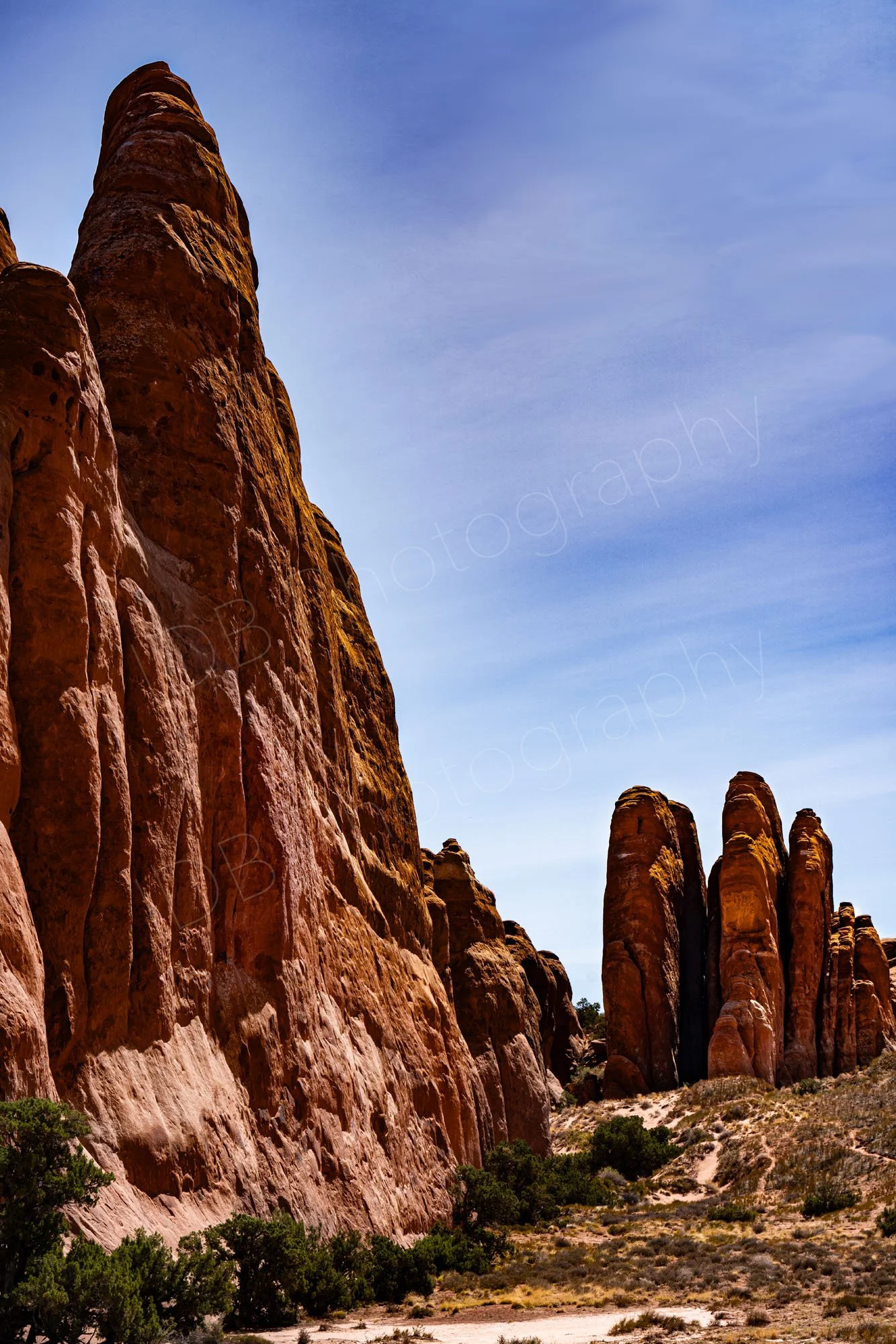 Towering sandstone fin formations at Arches National Park, Moab, Utah, USA, nice hazy cloud/blue sky background. 