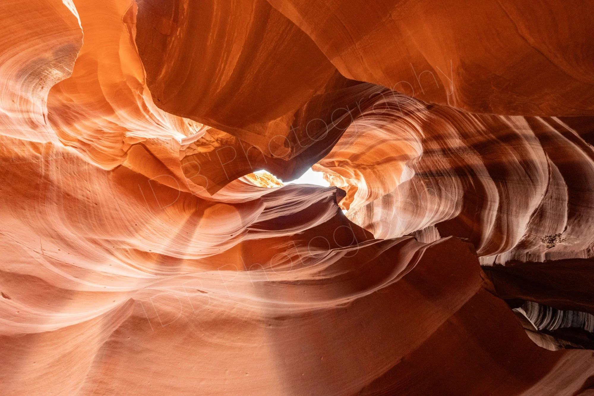 Beautiful light altering the colour tones of the scalloped rocks at Upper Antelope Canyon, Page, Arizona.