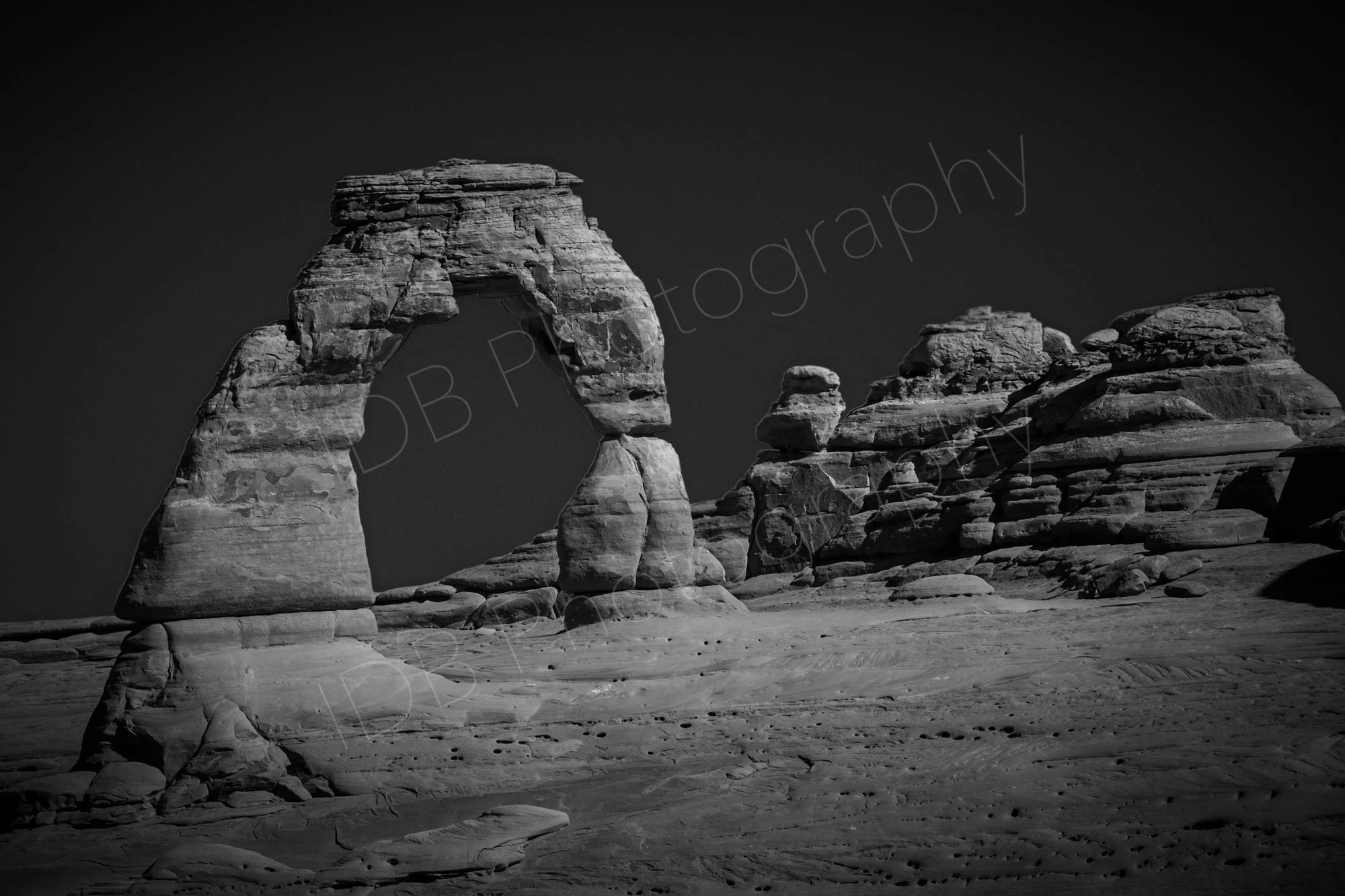A black and white image of Delicate Arch at Arches National Park, Utah, USA.