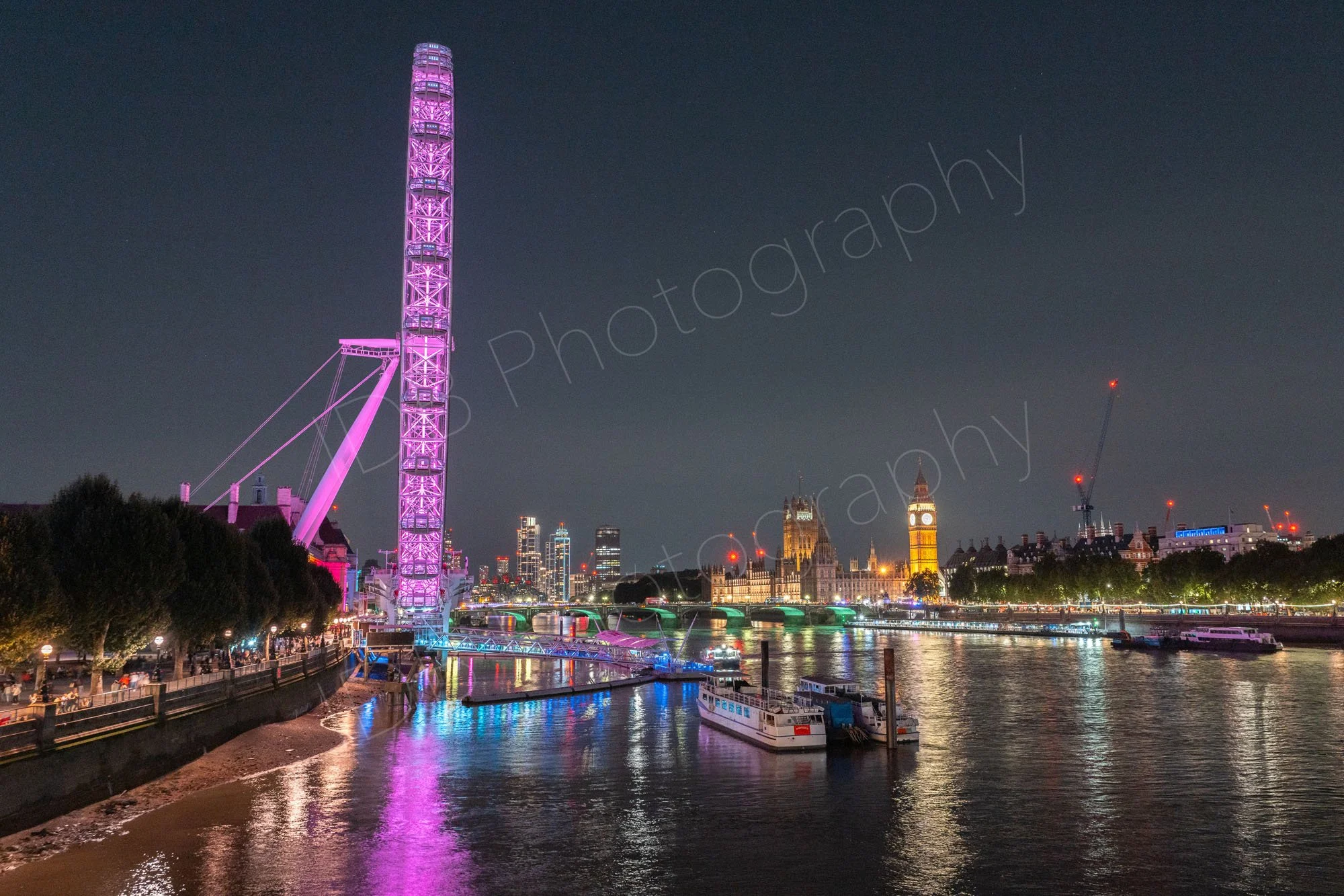 A night-time image from Waterloo Bridge towards the London Eye and The Houses of Parliament, nice reflections in the water.