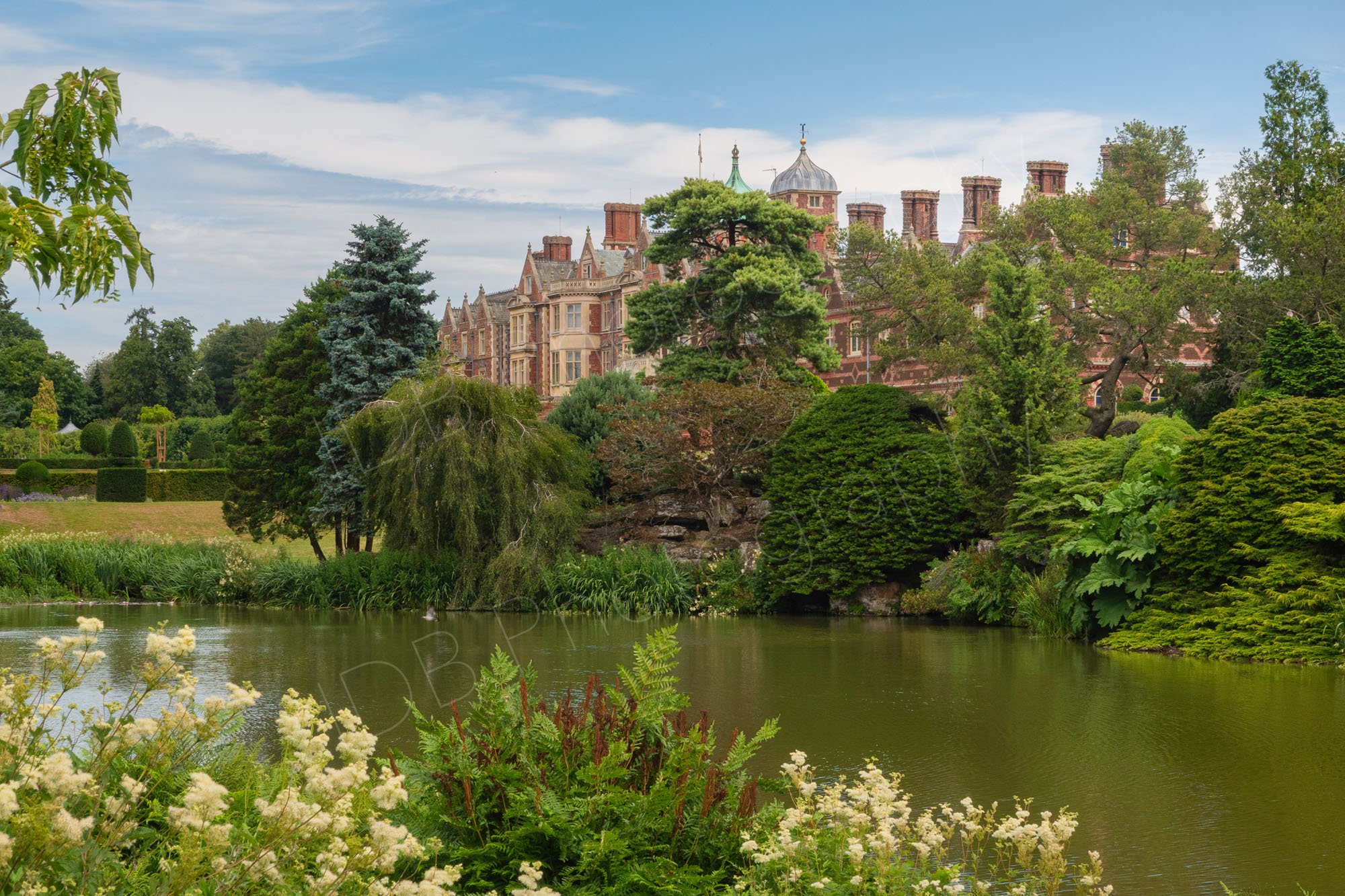 Sandringham House and its scenic lake nestled within the royal estate in Norfolk, England.