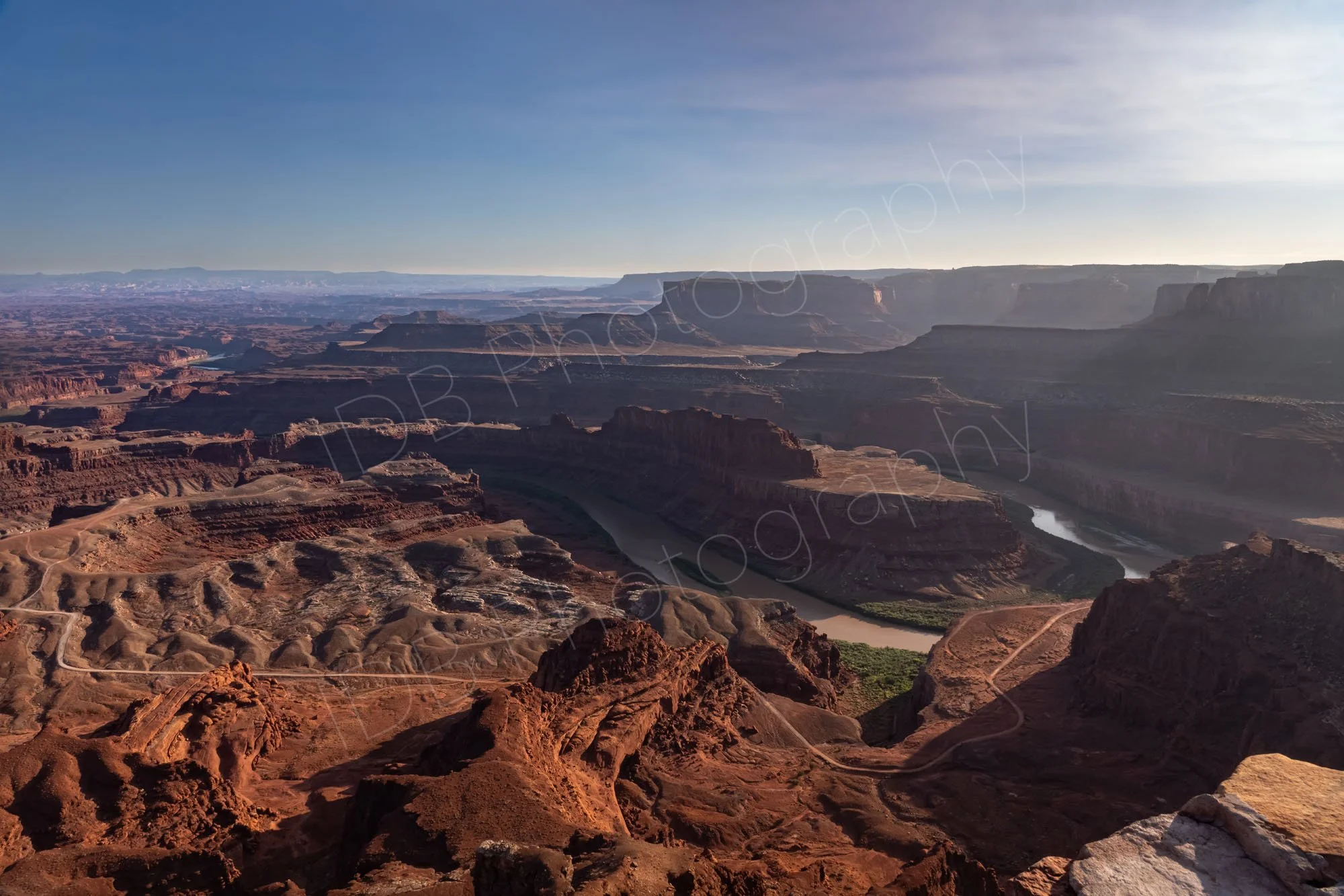The fantastic view of the canyons and the meandering Colorado River at Dead Horse Point State Park, Utah. Sunlight haze on right of image. 
