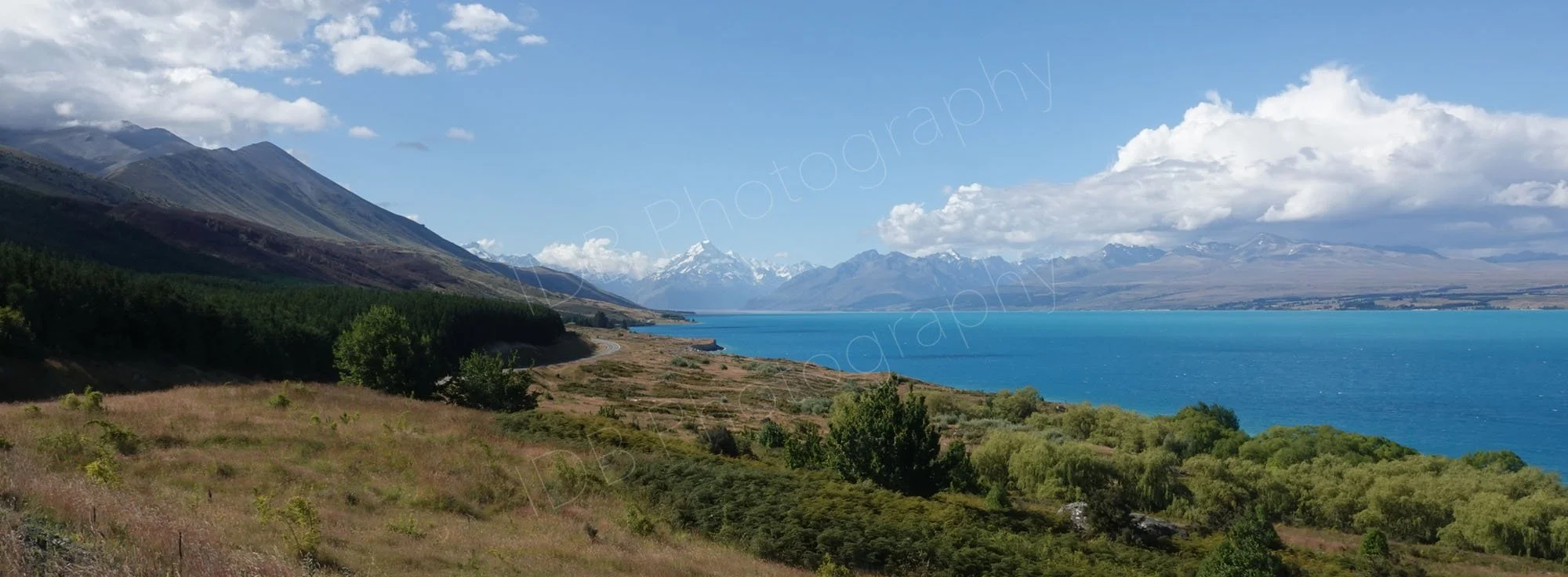 Panoramic type view of beautiful Lake Pukaki  with snow capped Mount Cook in the distance, Canterbury, New Zealand.
