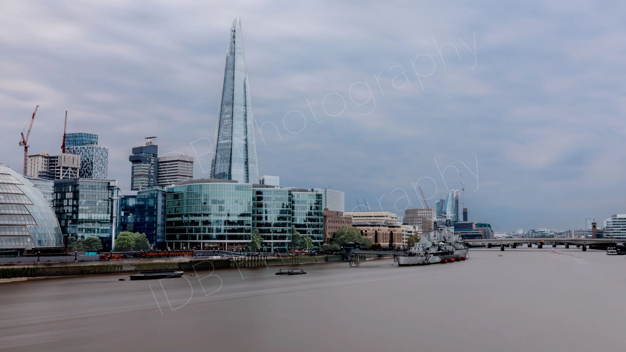 A long ND filter exposure along the Thames with the Shard, HMS Belfast and London Bridge clearly seen, smooth water and dynamic cloudy sky.