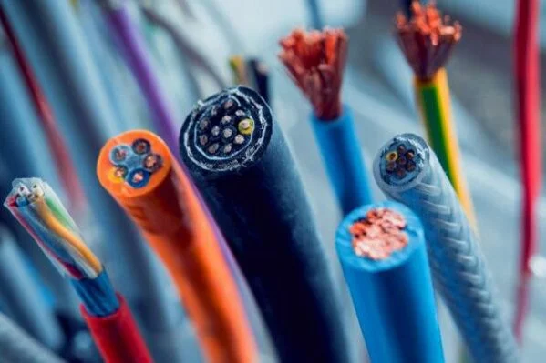 Close-up of various colored electrical cables with exposed ends showing internal wiring.