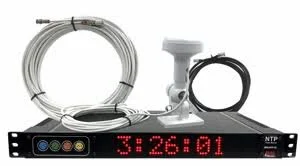 A digital television receiver with a black front panel displaying a red time readout. It has various cables and connectors on top, including a coiled white cable and a black cable, positioned on a plain white background.