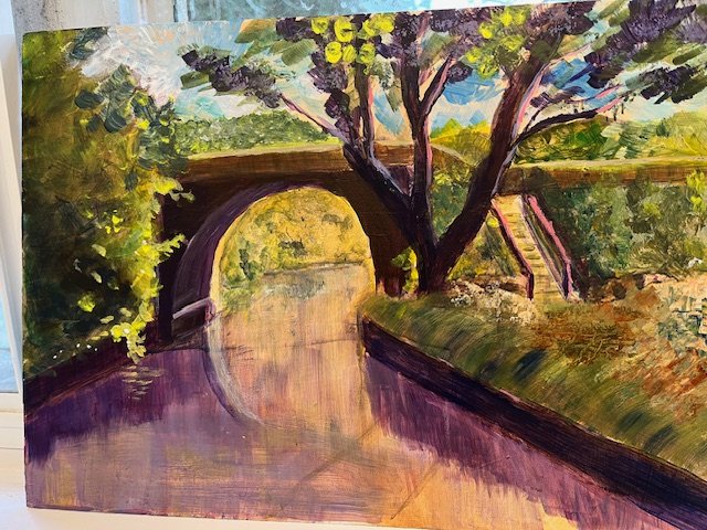 A colorful painting of a park scene featuring a bridge over a body of water, with trees and greenery along the water's edge.