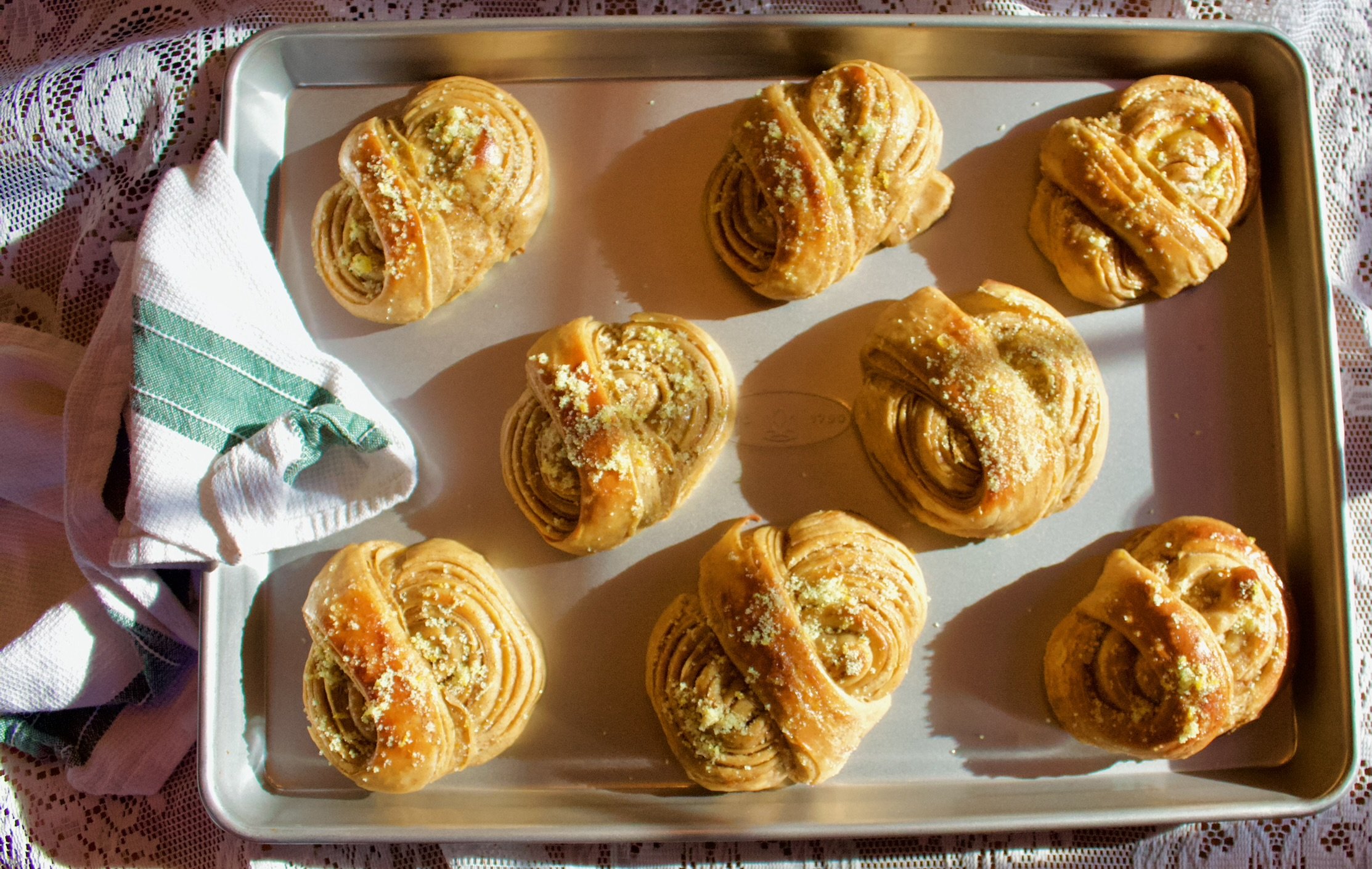 Image of orange morning buns on a sheet tray