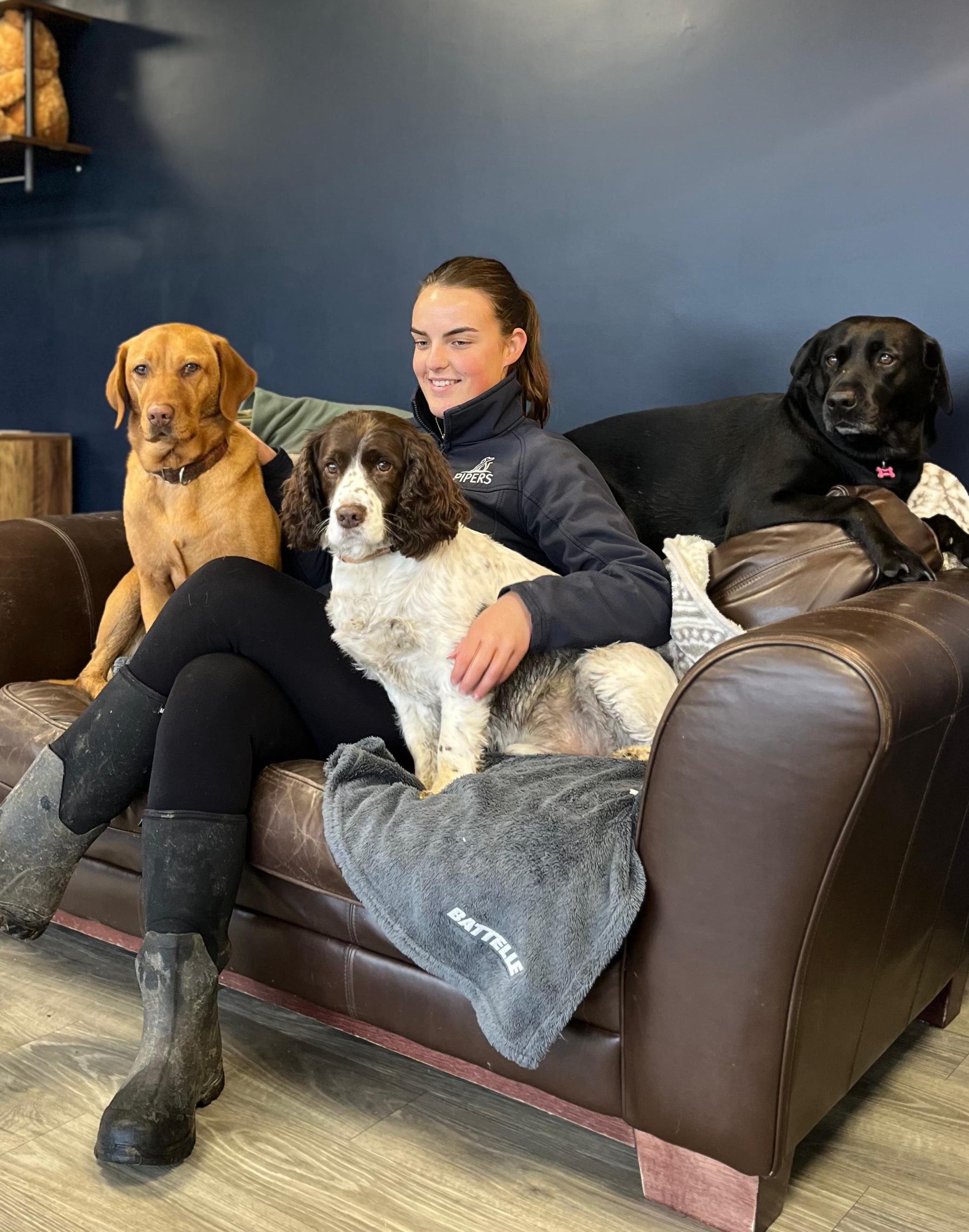 Pipers staff member Ellie, relaxes with some furry clients on the Pipers sofa in reception.